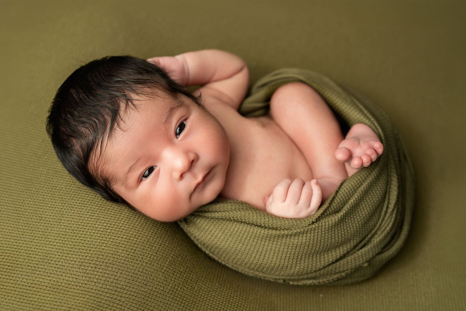 Sleeping newborn in wrap. Captured by a sought-after professional newborn photographer in Woodland Hills, Los Angeles.