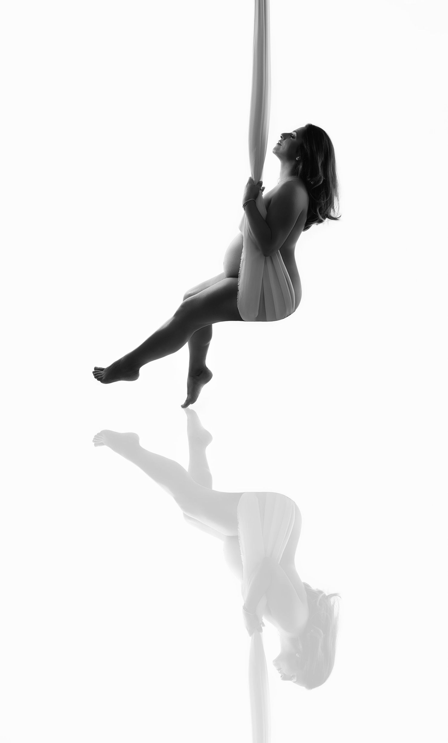 Pregnant mom in swing, at our Woodland Hills studio. The best maternity photographer in Los Angeles.
