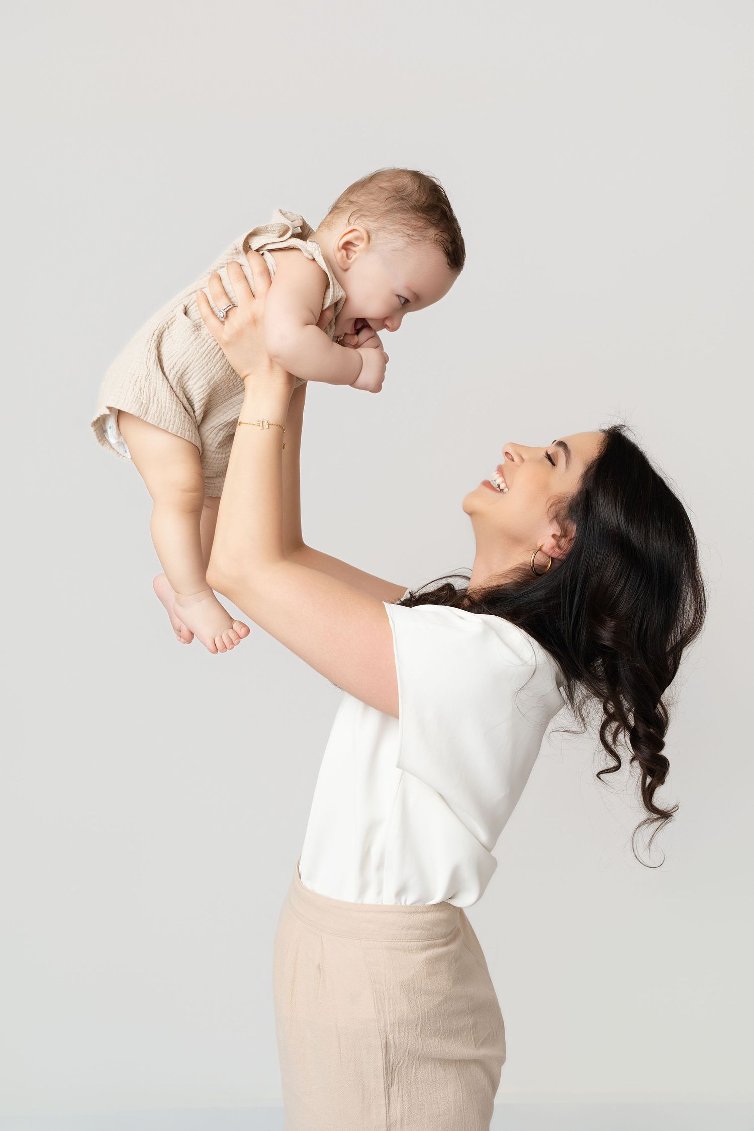mom and baby on white backdrop. Best maternity and newborn photographers in Los Angeles, serving Woodland Hills.
