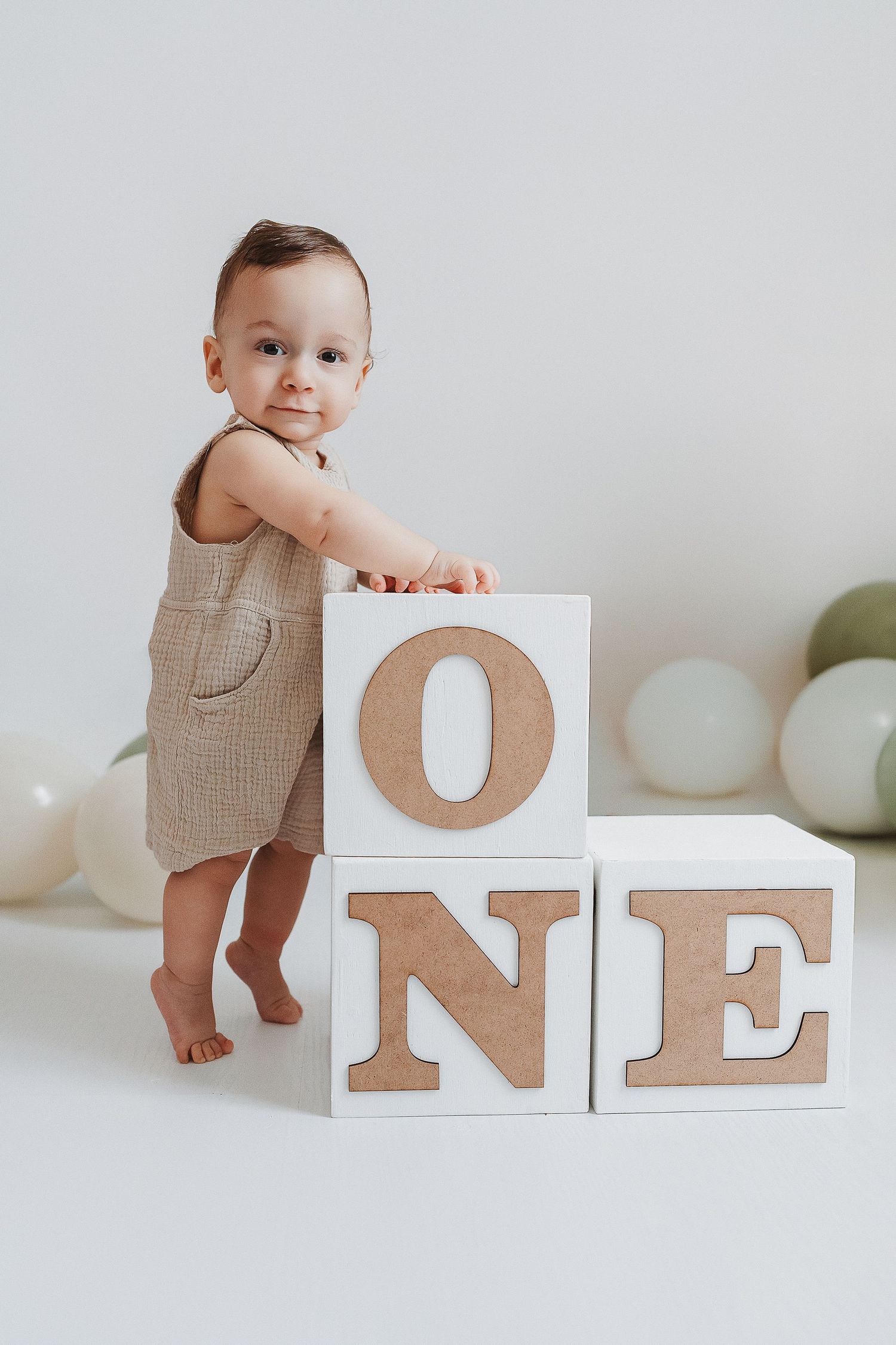 baby standing next to blocks in our Woodland Hills studio. Amazing milestone photography in Los Angeles & the SF Valley.
