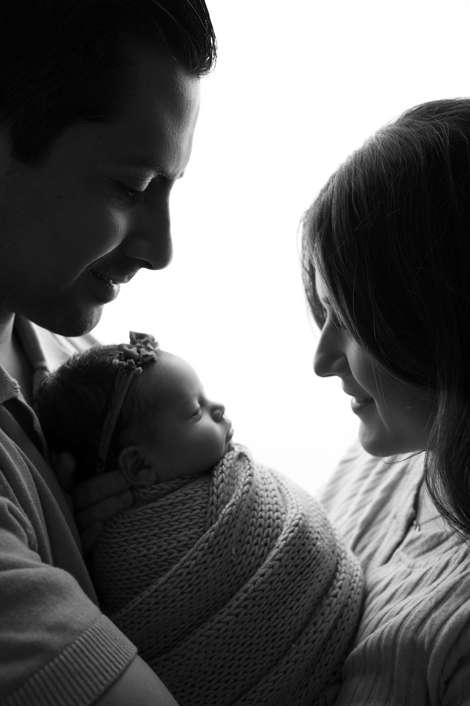 Sleeping newborn with parents. Captured by a sought-after professional newborn photographer in Woodland Hills, Los Angeles.