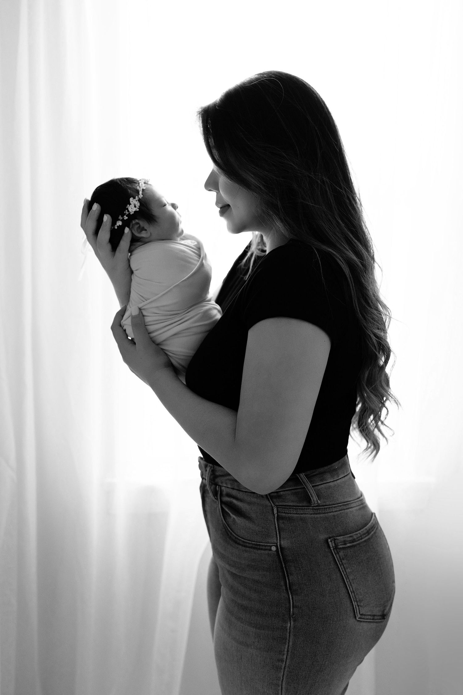 Sleeping newborn with parents. Captured by a sought-after professional newborn photographer in Woodland Hills, Los Angeles.