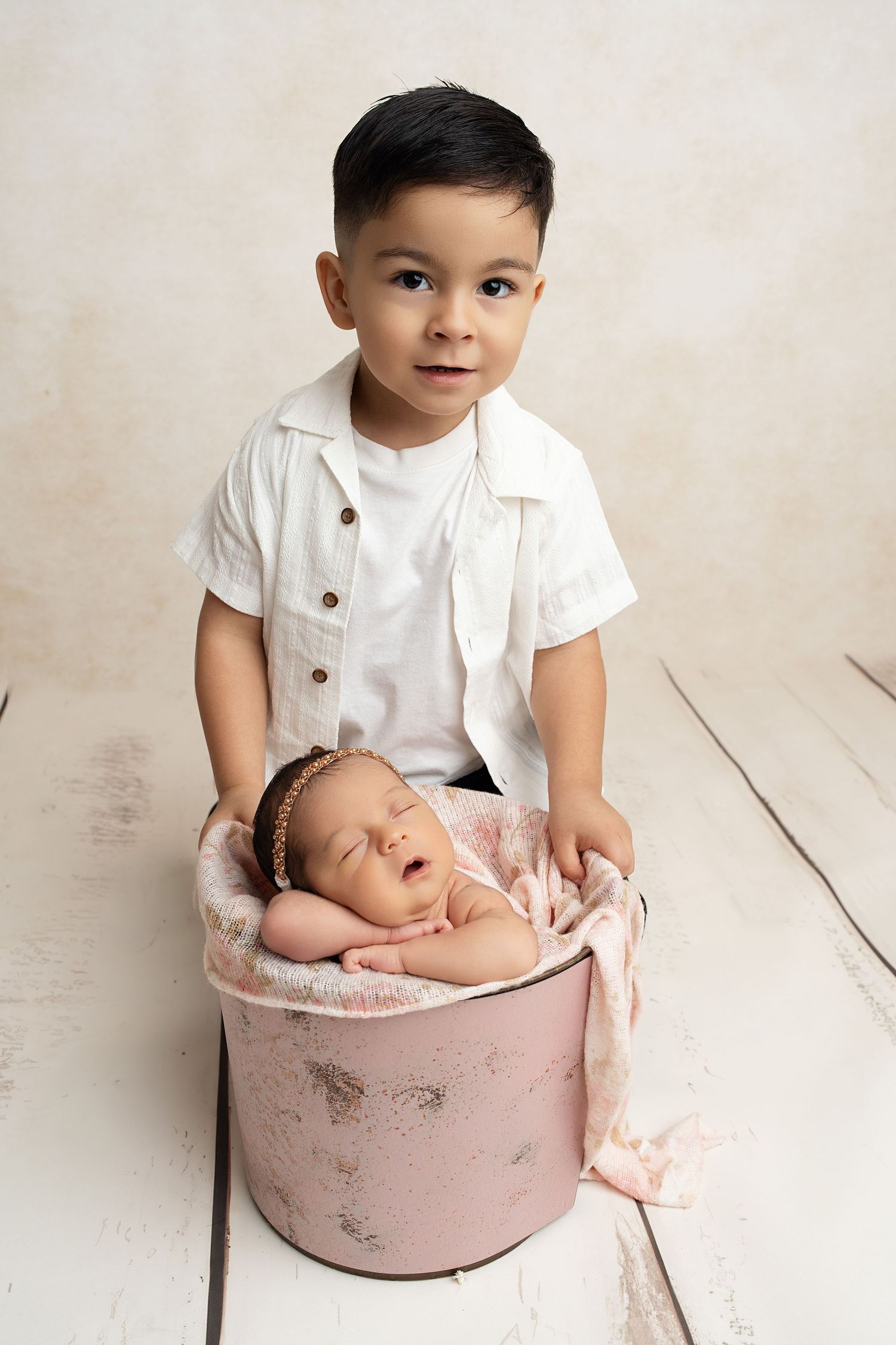Sleeping newborn in bucket. Captured by a sought-after professional newborn photographer in Woodland Hills, Los Angeles.