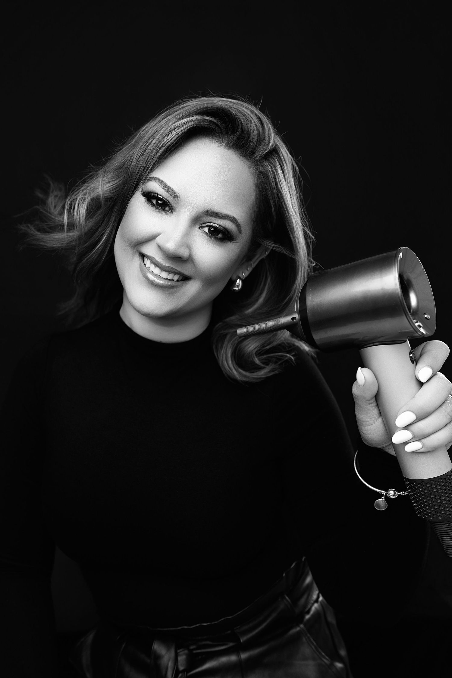 woman on black backrop, on a white backdrop. Best maternity and newborn photographers in Los Angeles, serving Woodland Hills.