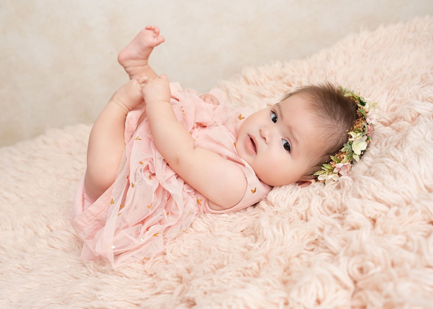 baby reaching feet in our Woodland Hills studio. Amazing milestone photography in Los Angeles & the SF Valley.