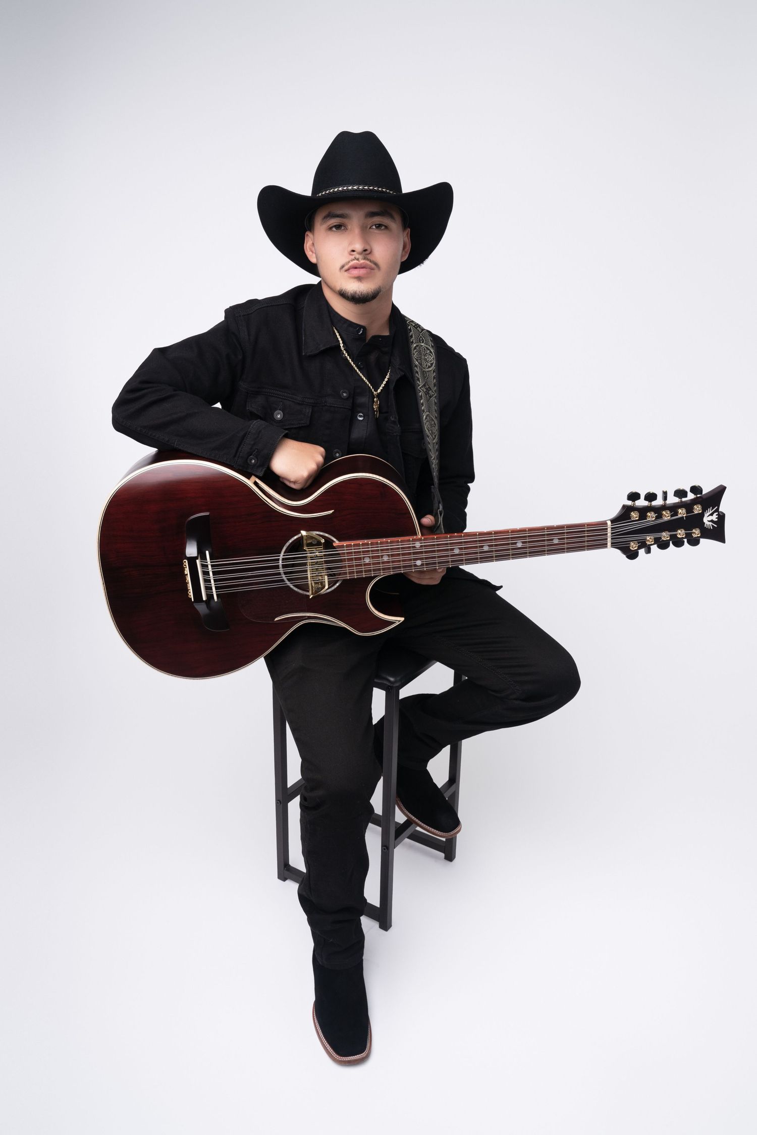 man with guitar on a white backdrop. Best maternity and newborn photographers in Los Angeles, serving Woodland Hills.