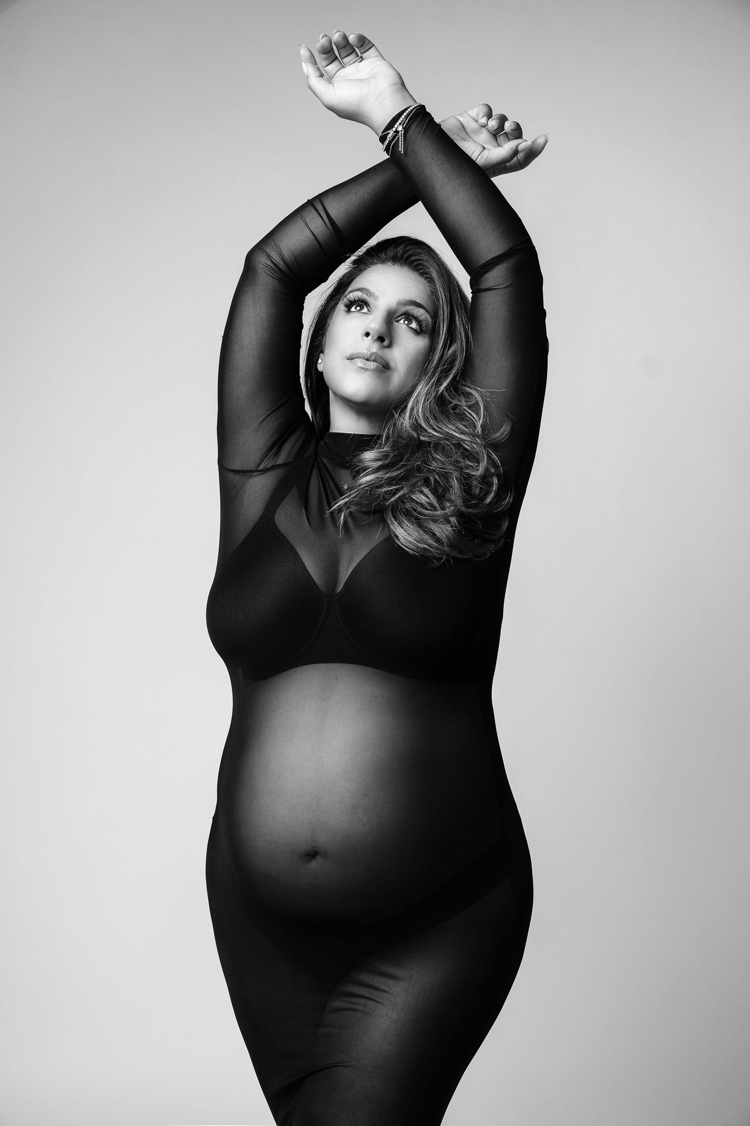 Pregnant mom in sheer gown, at our Woodland Hills studio. The best maternity photographer in Los Angeles.