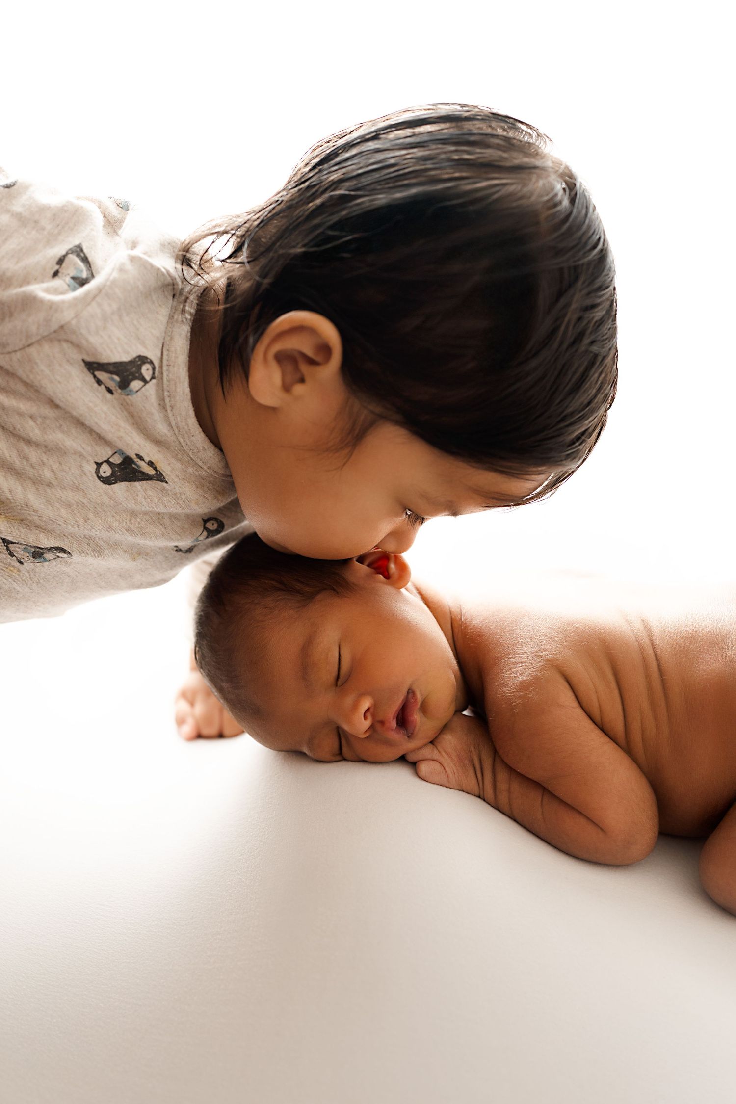 newborn and sibling. Captured by a sought-after professional newborn photographer in Woodland Hills, Los Angeles.