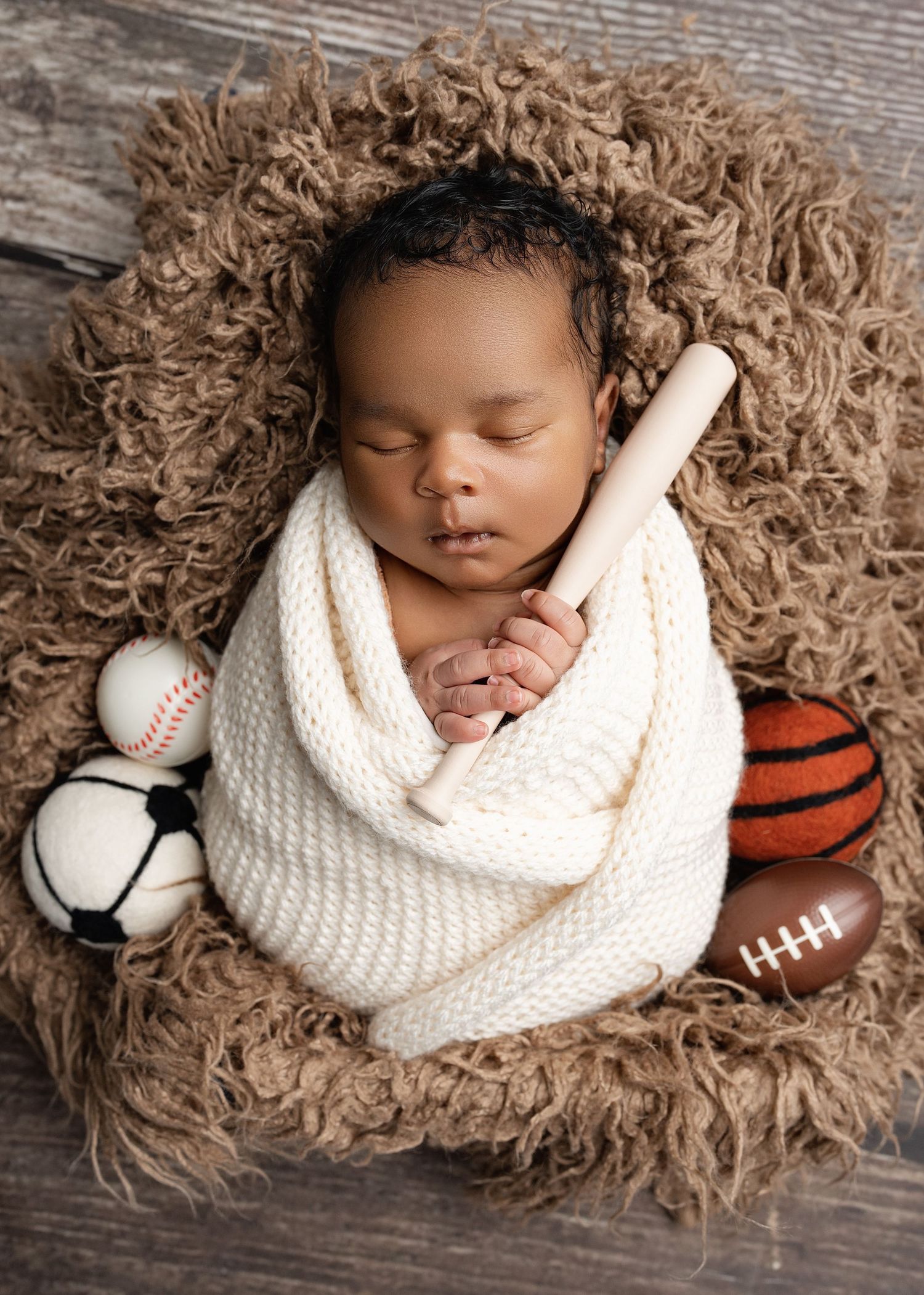 Sleeping newborn in fur. Captured by a sought-after professional newborn photographer in Woodland Hills, Los Angeles.