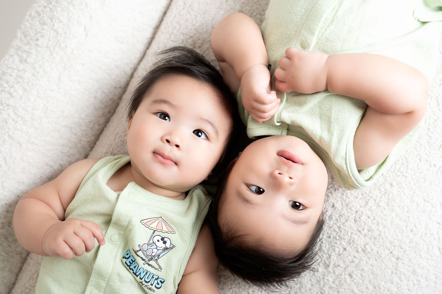 twin babies smiling in our Woodland Hills studio. Amazing milestone photography in Los Angeles & the SF Valley.