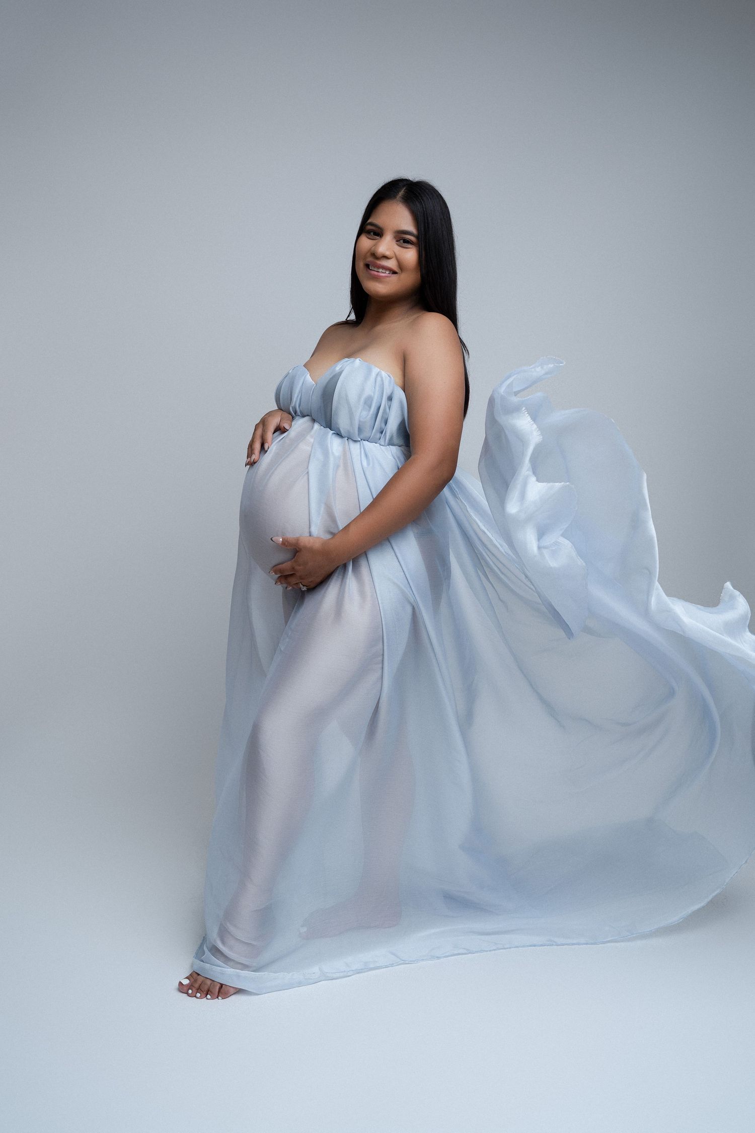 Pregnant mom and fabric poss at our Woodland Hills studio. The best maternity photographer in Los Angeles.