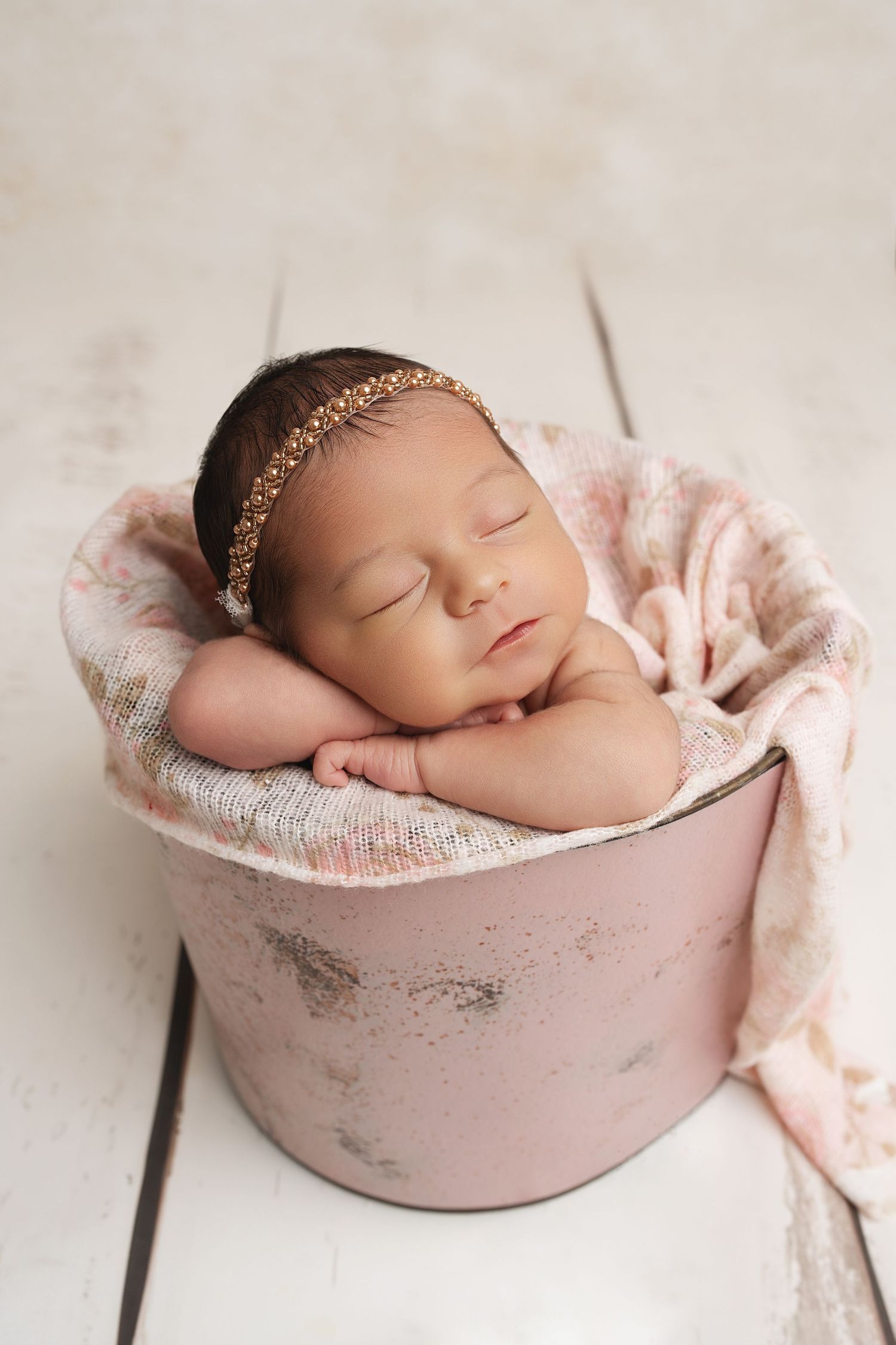 Sleeping newborn in basket. Captured by a sought-after professional newborn photographer in Woodland Hills, Los Angeles.