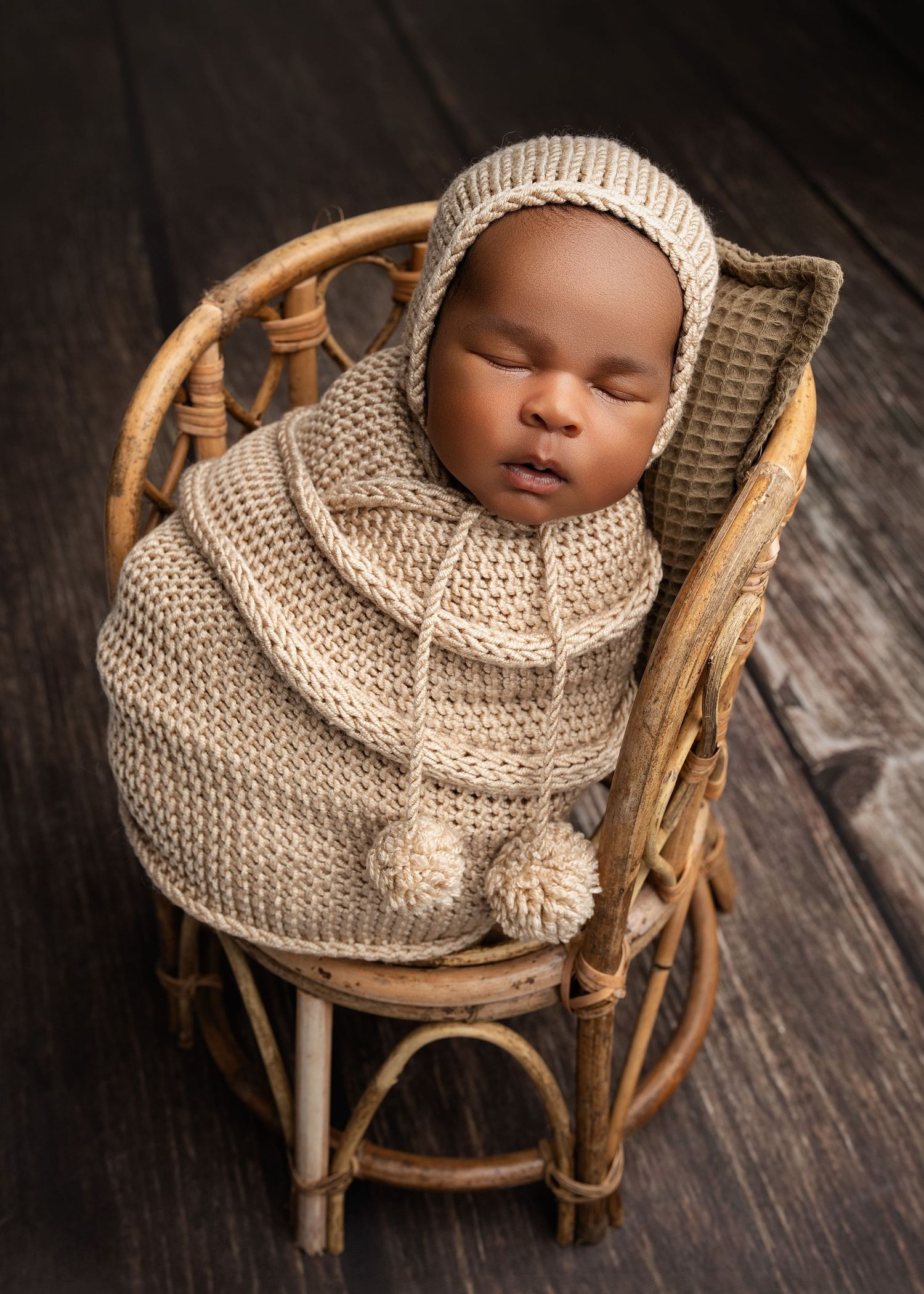 newborn in rattan chair prop. Captured by a sought-after professional newborn photographer in Woodland Hills, Los Angeles.