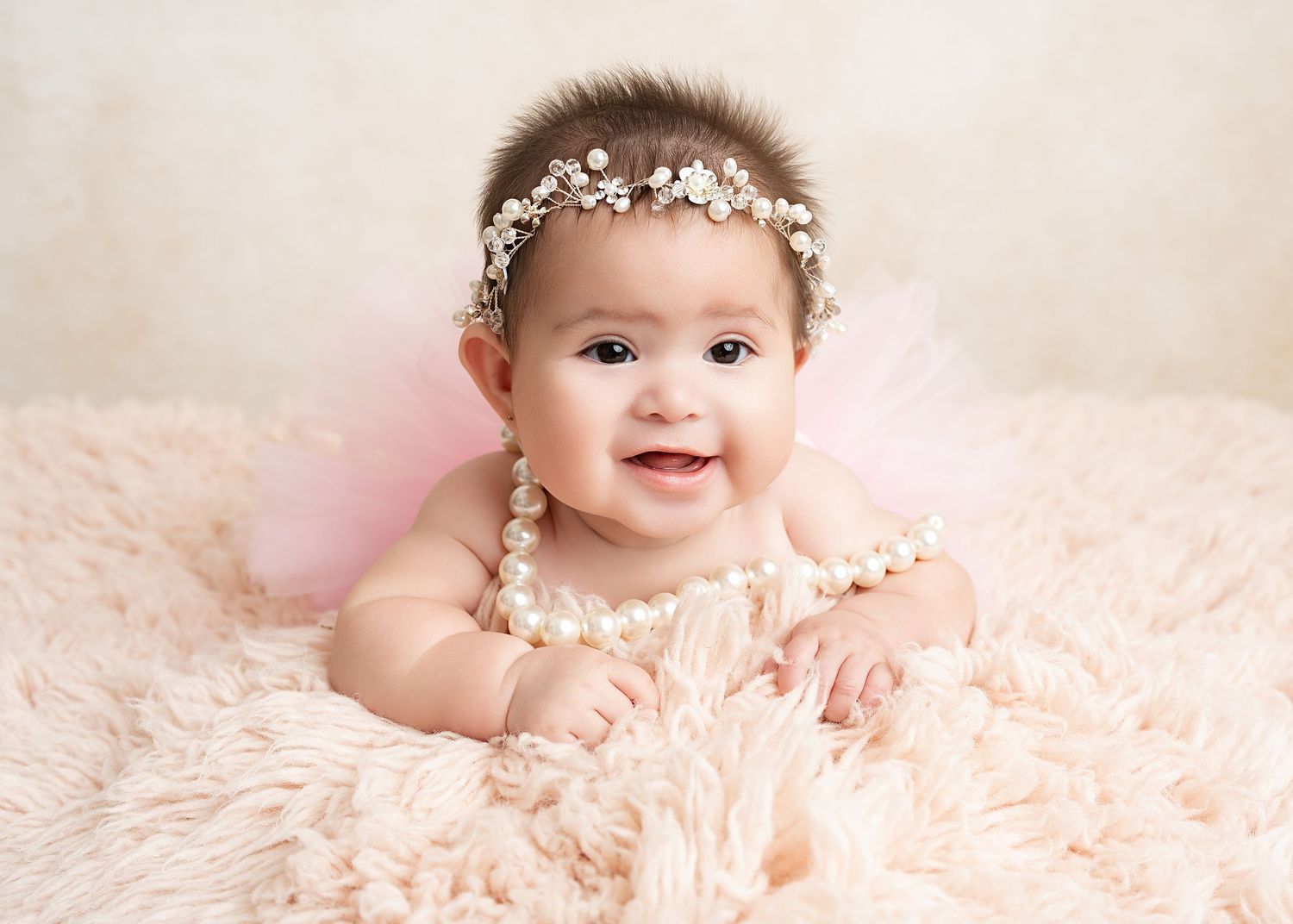Smiling baby on tummy in our Woodland Hills studio. Amazing milestone photography in Los Angeles & the SF Valley.