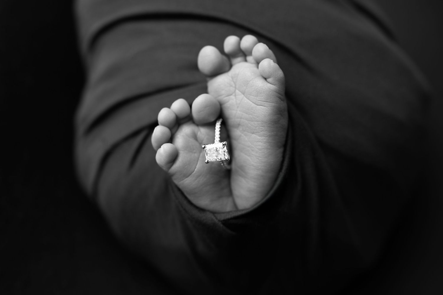 Newborn toes and engagement ring. Captured by a sought-after professional newborn photographer in Woodland Hills, Los Angeles.