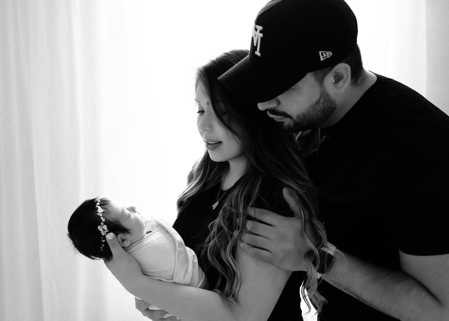 Sleeping newborn with parents. Captured by a sought-after professional newborn photographer in Woodland Hills, Los Angeles.