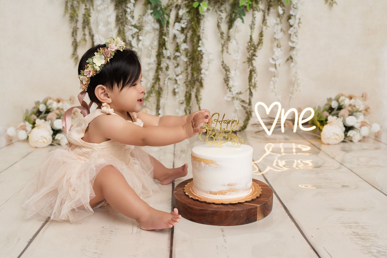 baby reaching for cake in our Woodland Hills studio. Amazing milestone photography in Los Angeles & the SF Valley.