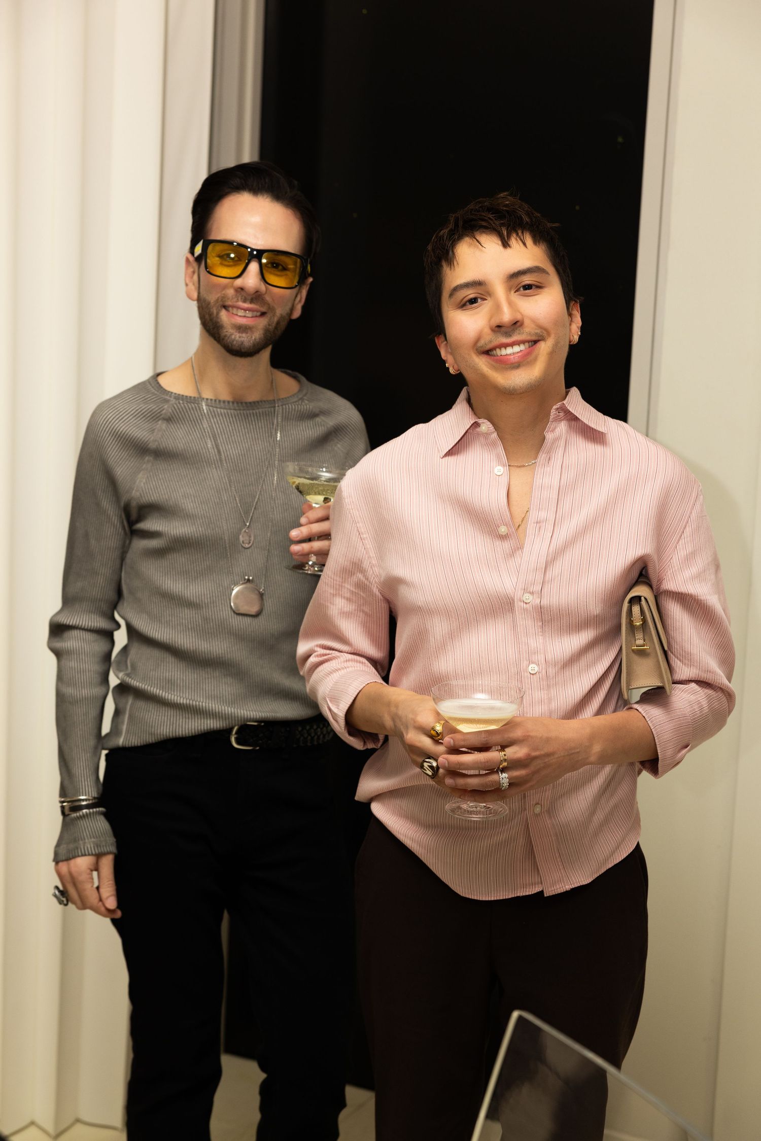 Guests posing for a photo at a Flying Solo fashion event in New York City.