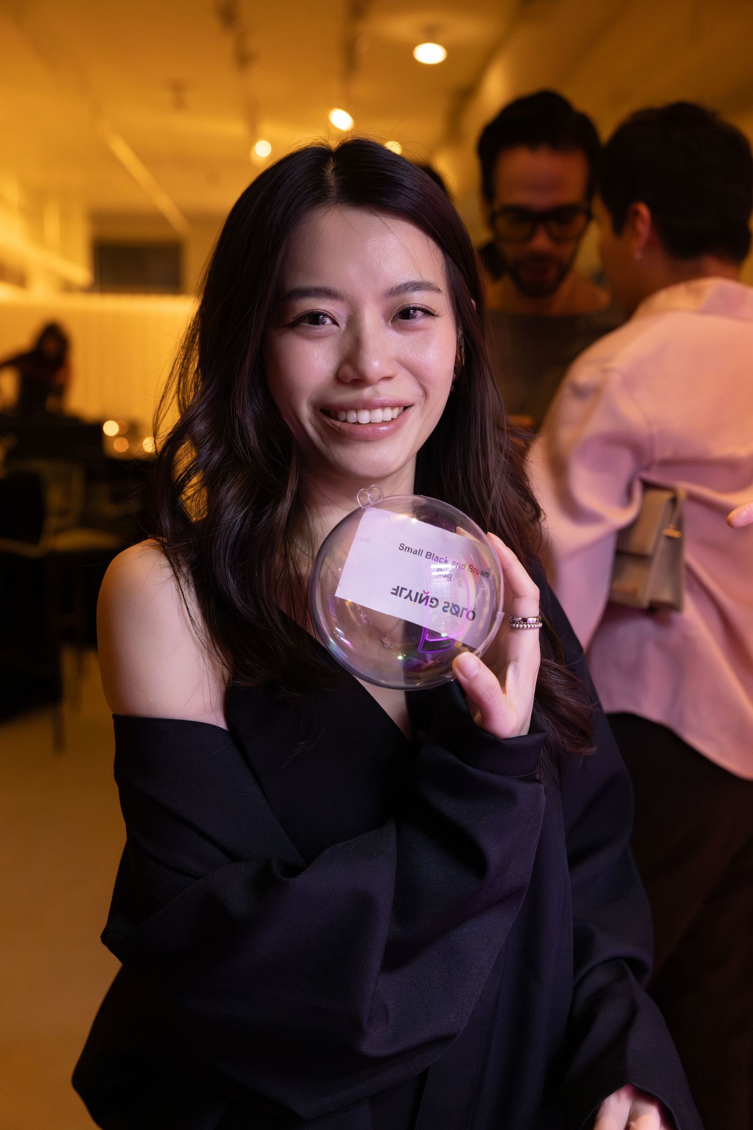 Guest smiling while attending a Flying Solo fashion event in New York City.