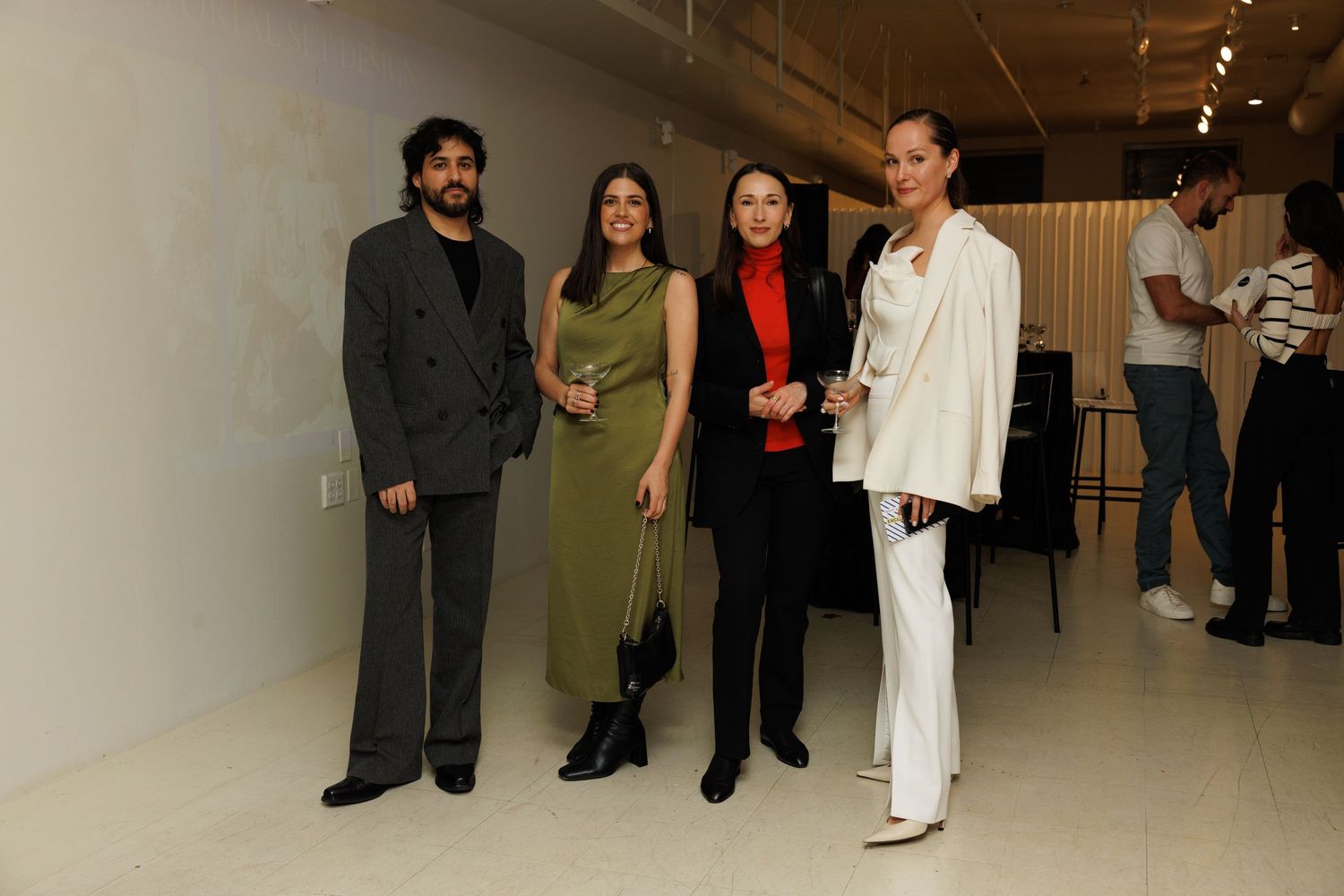 Guests posing together at a Flying Solo fashion event in New York City.
