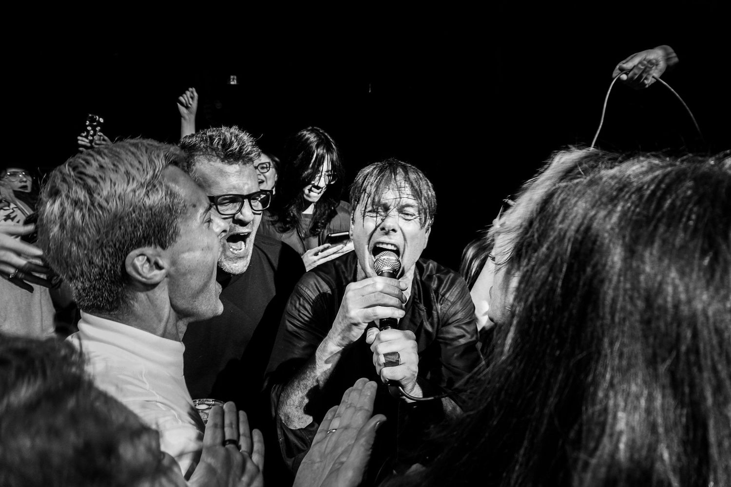 Suede performing live at Massey Hall in Toronto, photographed by Lisa Mark in 2022.