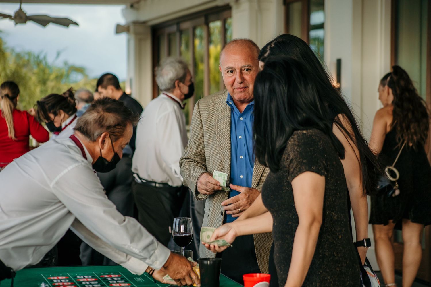 Guests enjoying drinks and conversation at an elegant outdoor reception.