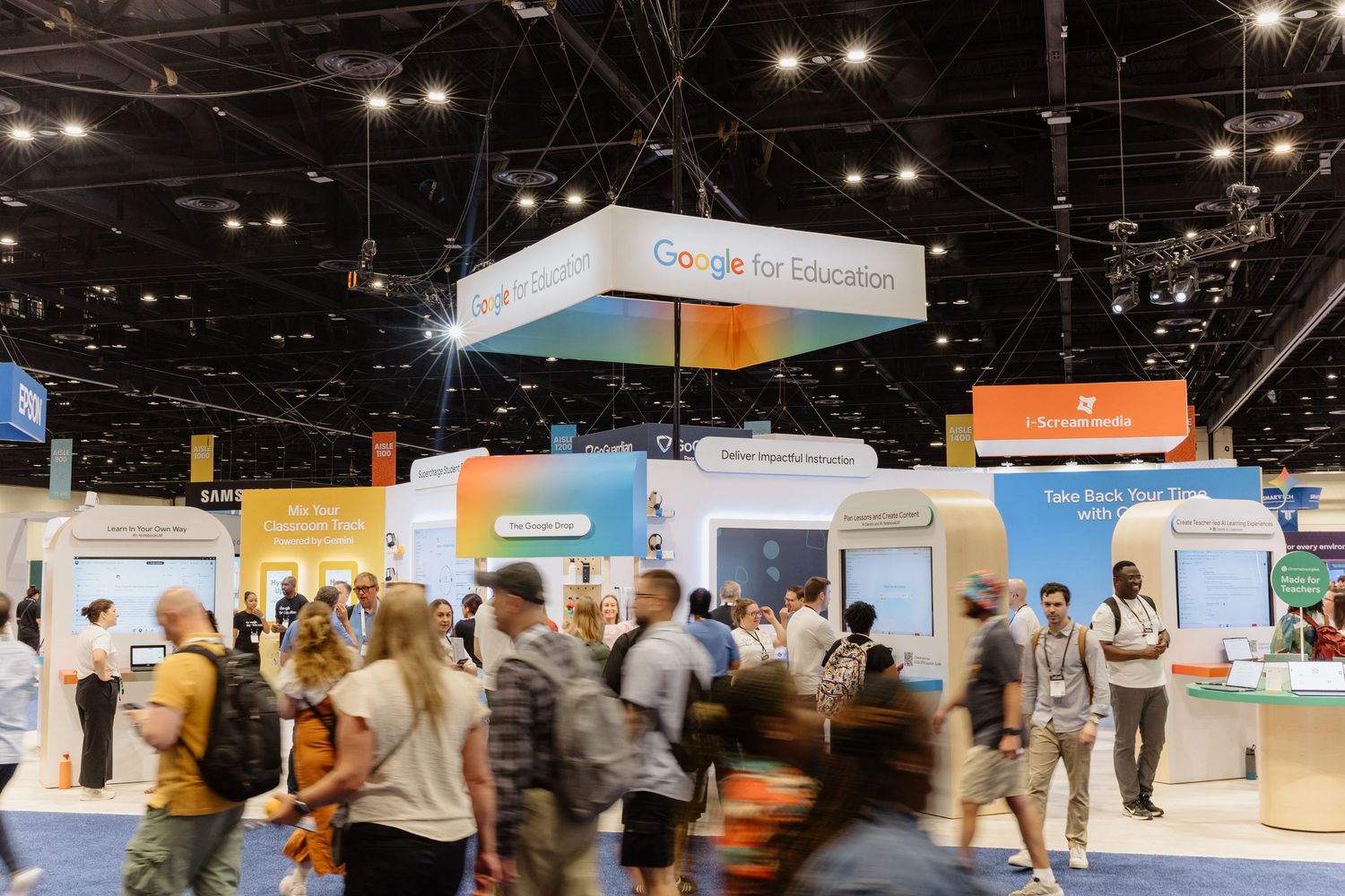 Busy Google for Education expo booth with attendees exploring displays at a large educational technology conference.