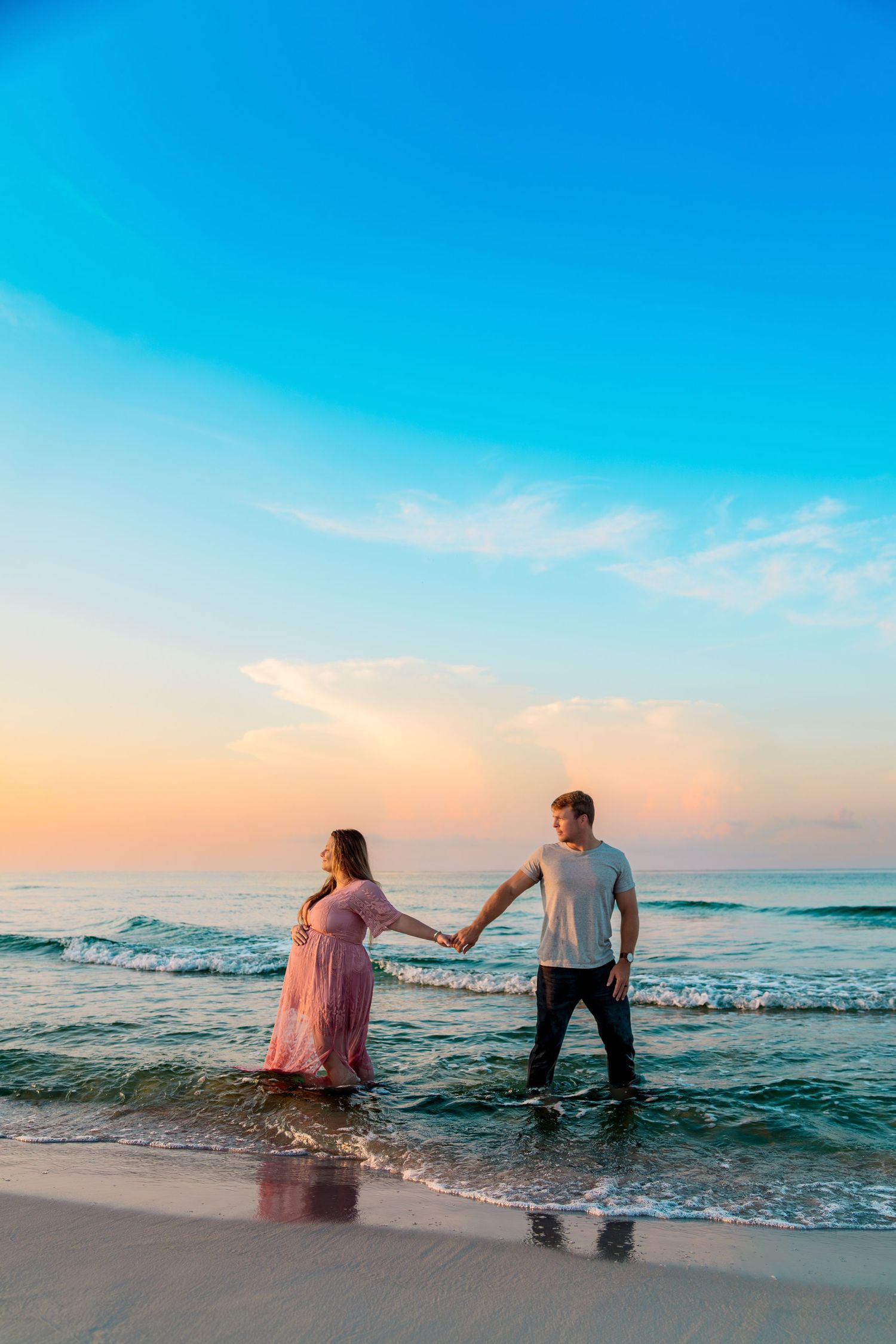 Outdoor maternity session capturing movement and connection, photographed by Sierra Lopez Productions.