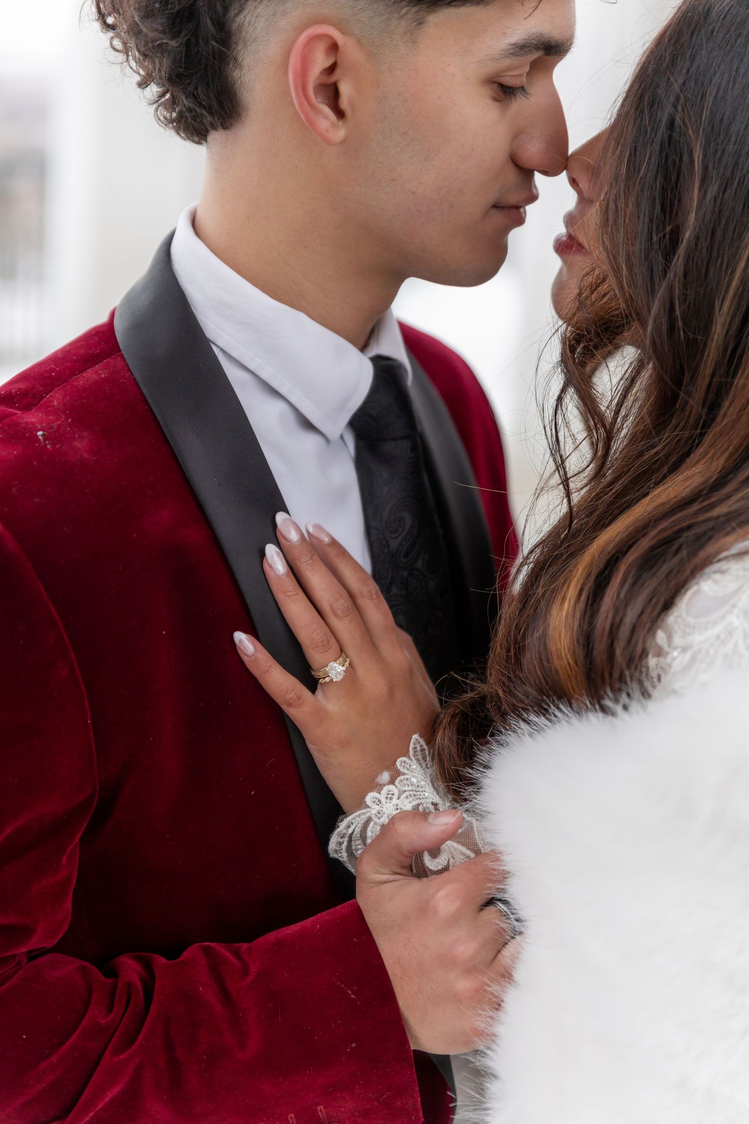 Cora Emilie Media -Romantic wedding portraits showing intimate moments between newlyweds in burgundy and white.