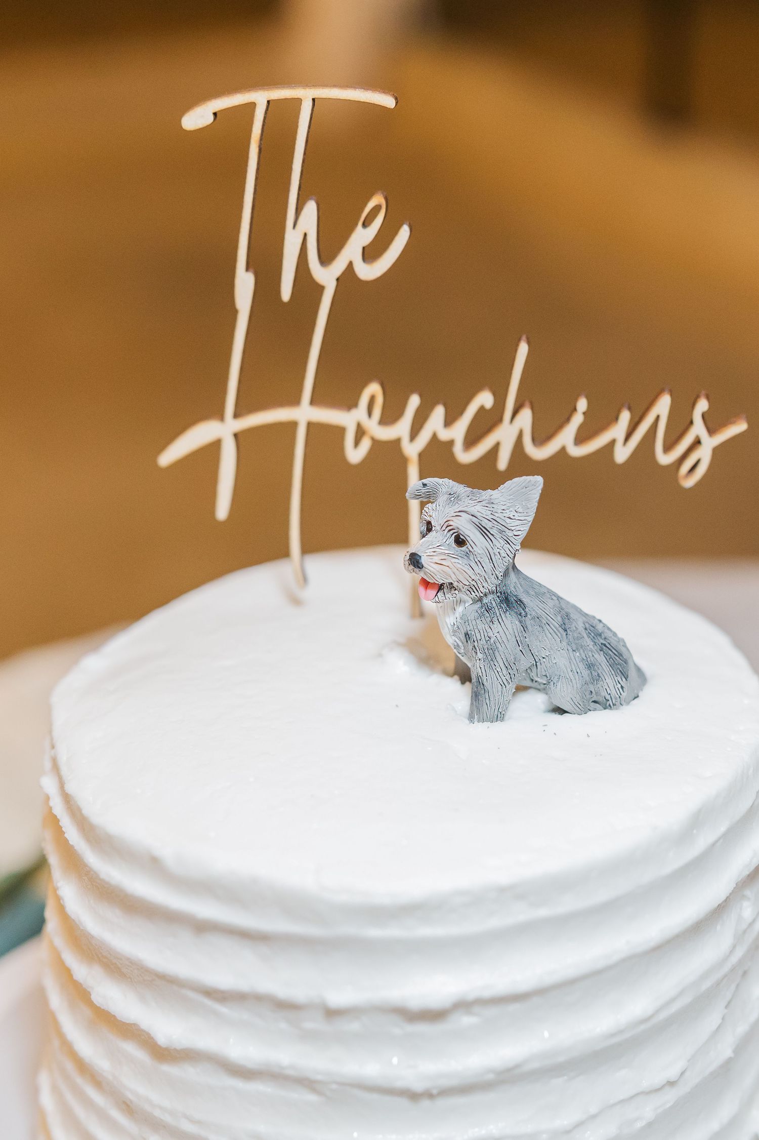 Elegant white wedding cake topped with a custom \
