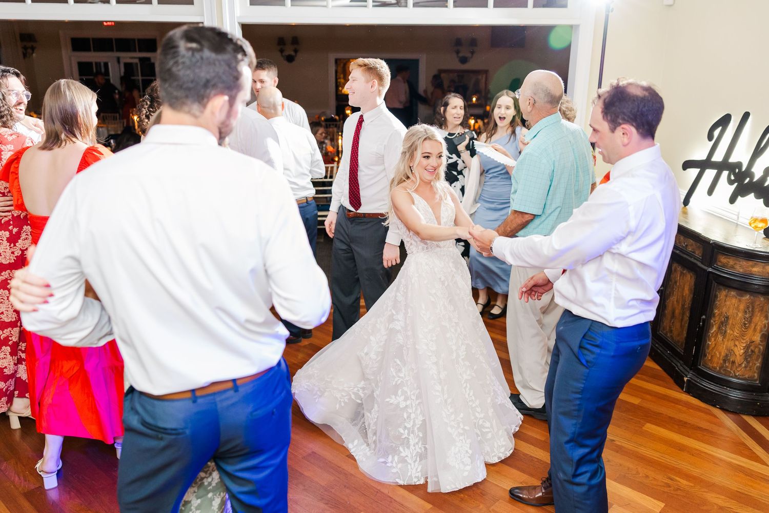 Wedding guests dancing and celebrating together at a lively reception party.