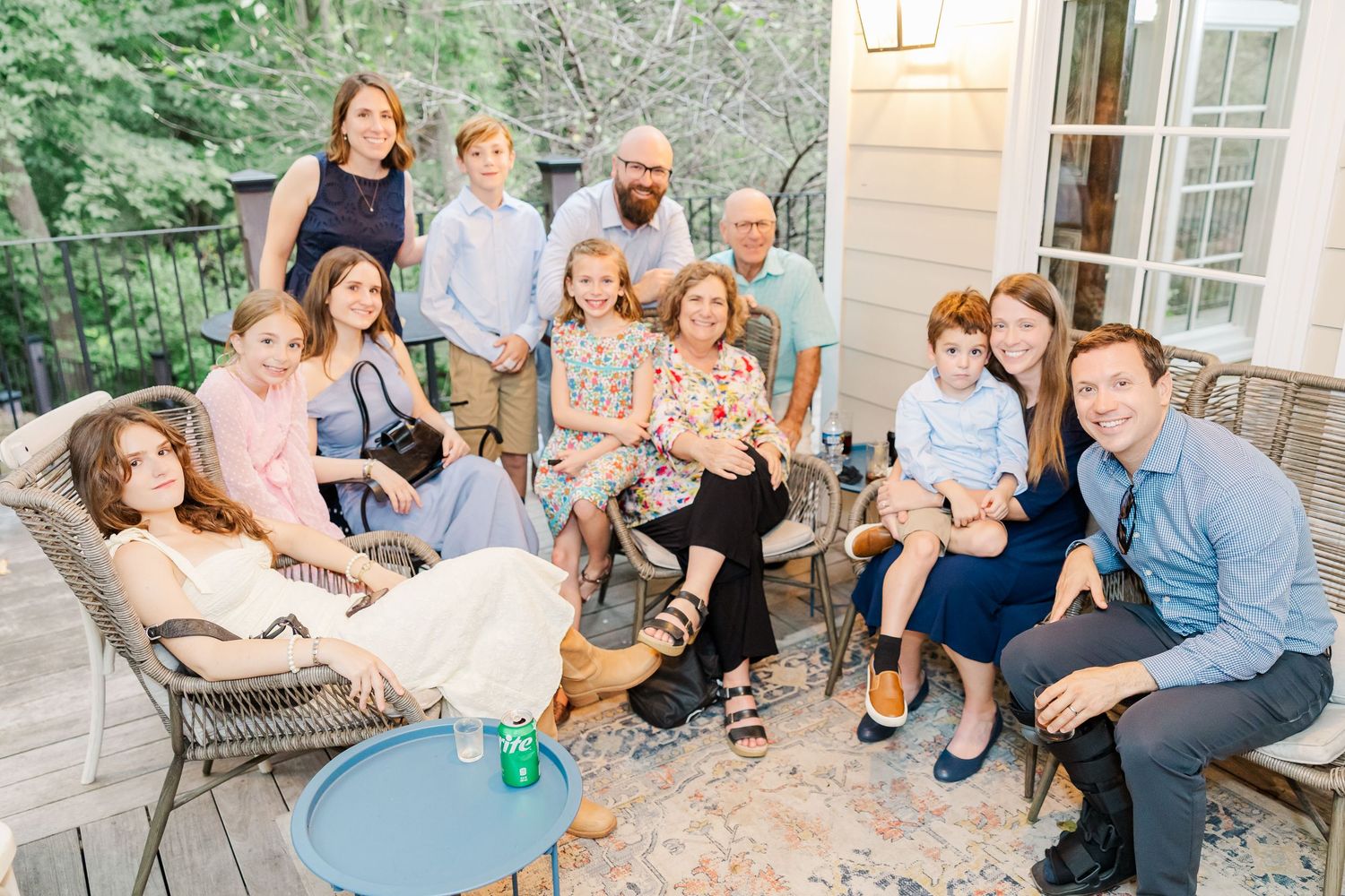 A group of people gathered outdoors on a patio enjoying a casual social gathering.