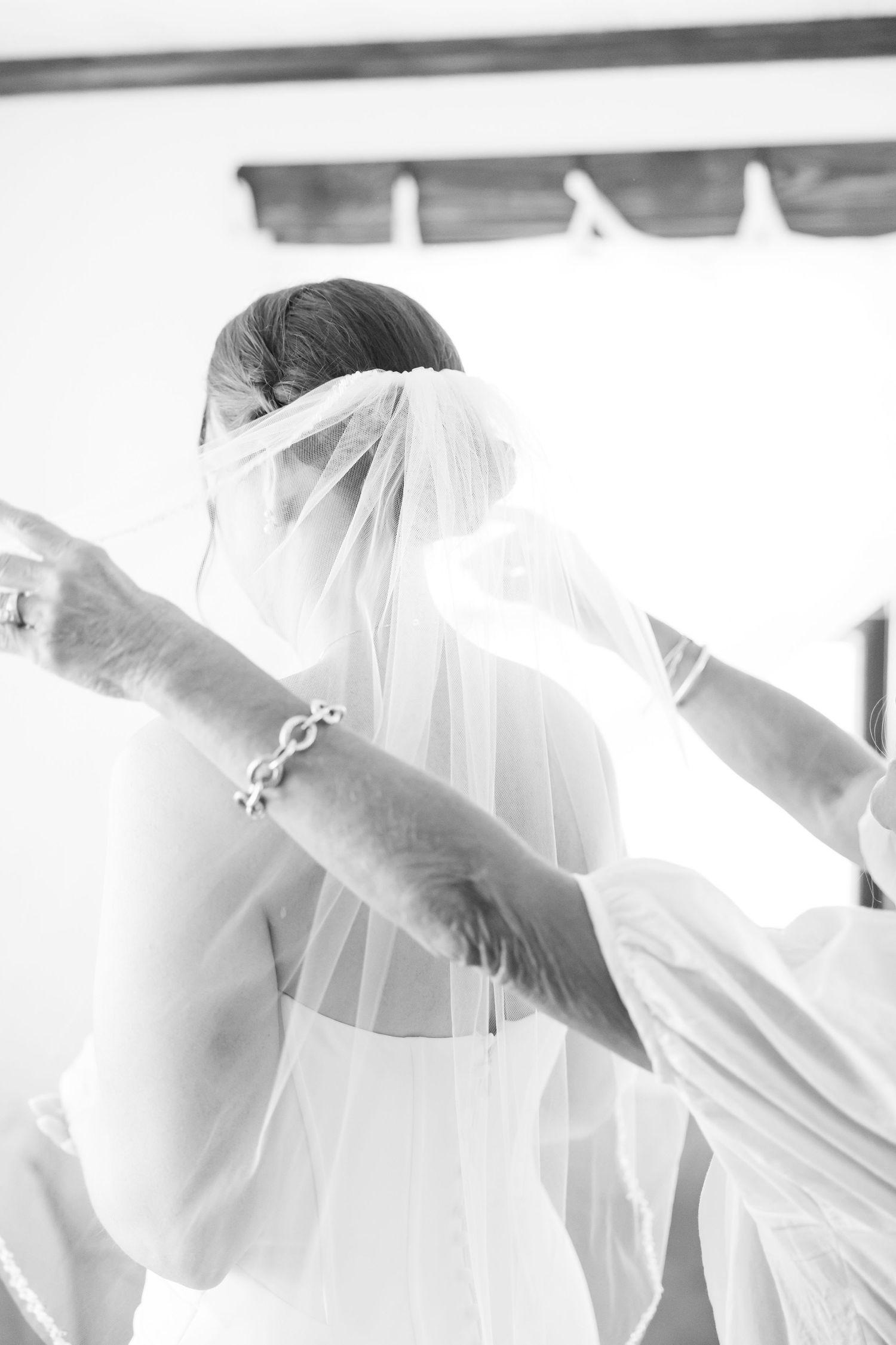 Multiple white-clad figures in a row showing movement and flowing fabric in a bright setting.