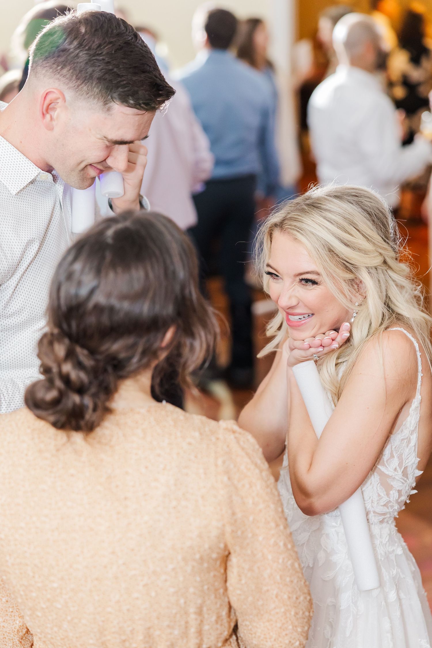 Wedding celebration with guests sharing joyful moments on the dance floor.