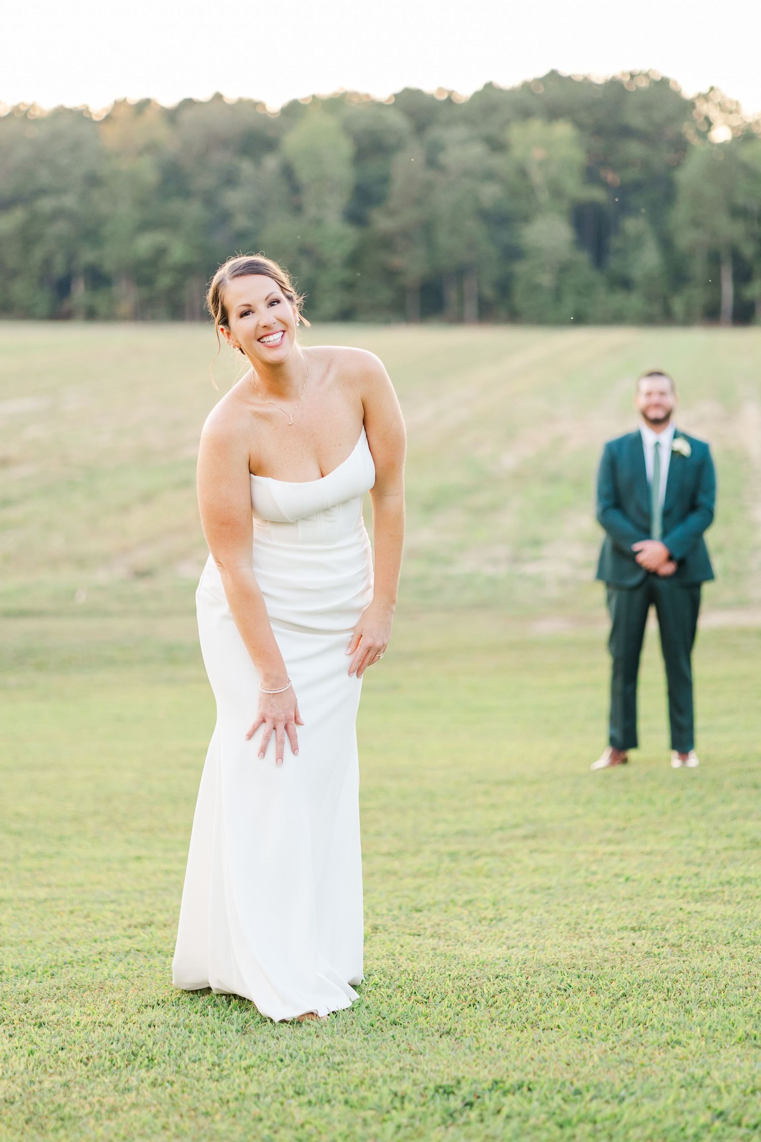 A series of playful poses on a grassy hill during a wedding photoshoot.