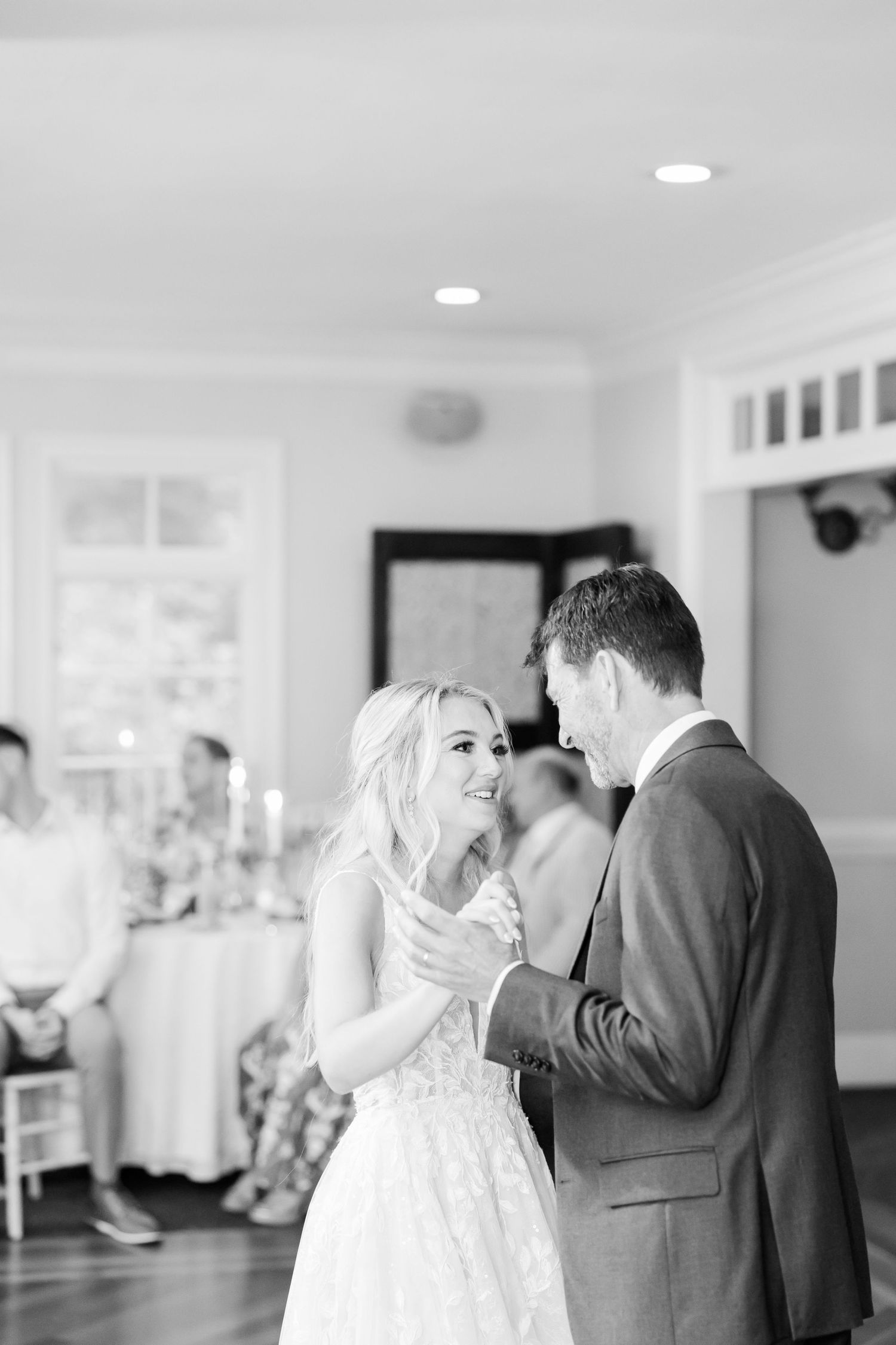 Black and white photo of wedding couple sharing an intimate moment during their first dance.