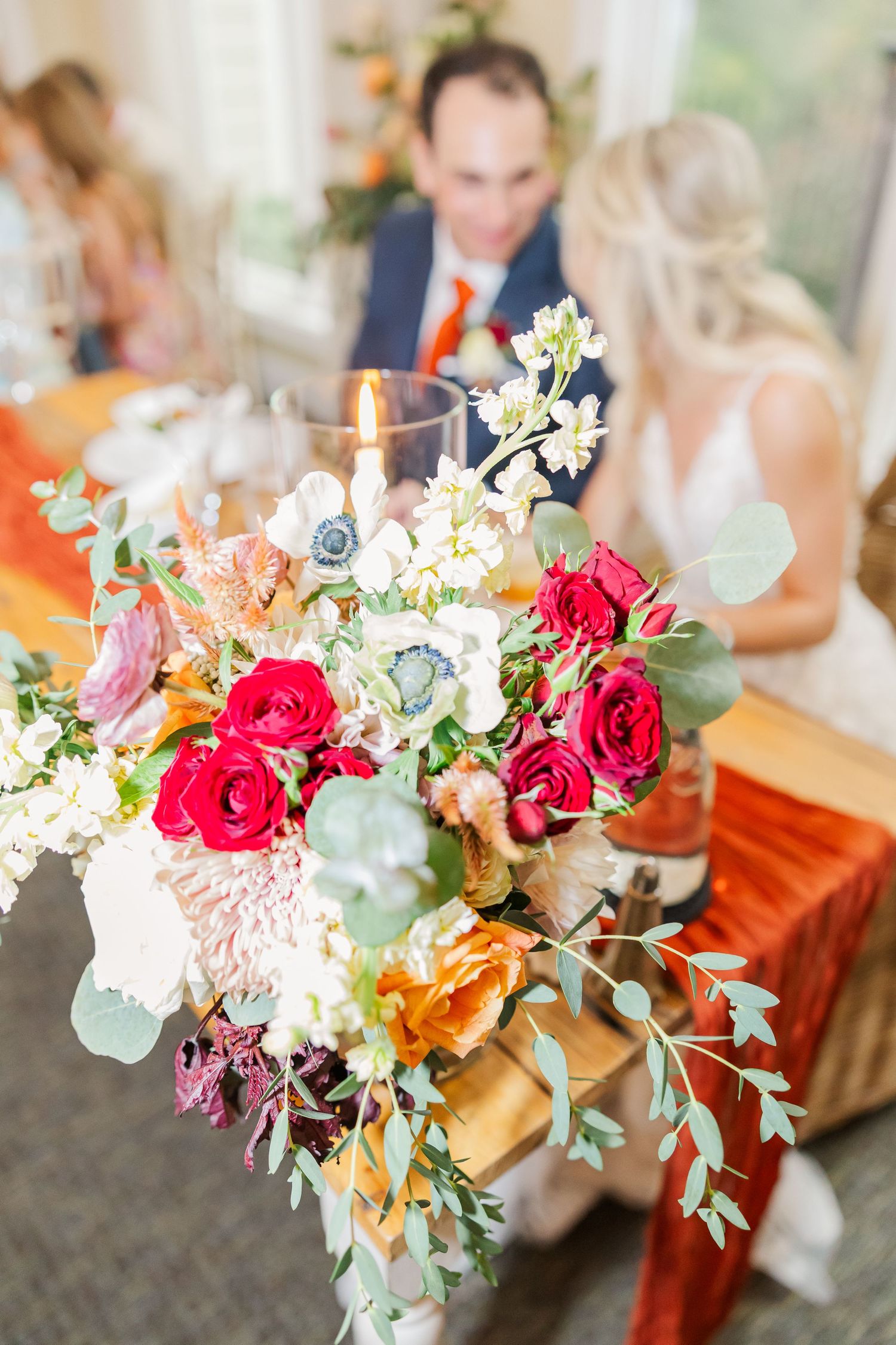 Vibrant wedding floral arrangements featuring pink roses, white flowers, and eucalyptus leaves displayed in a series.
