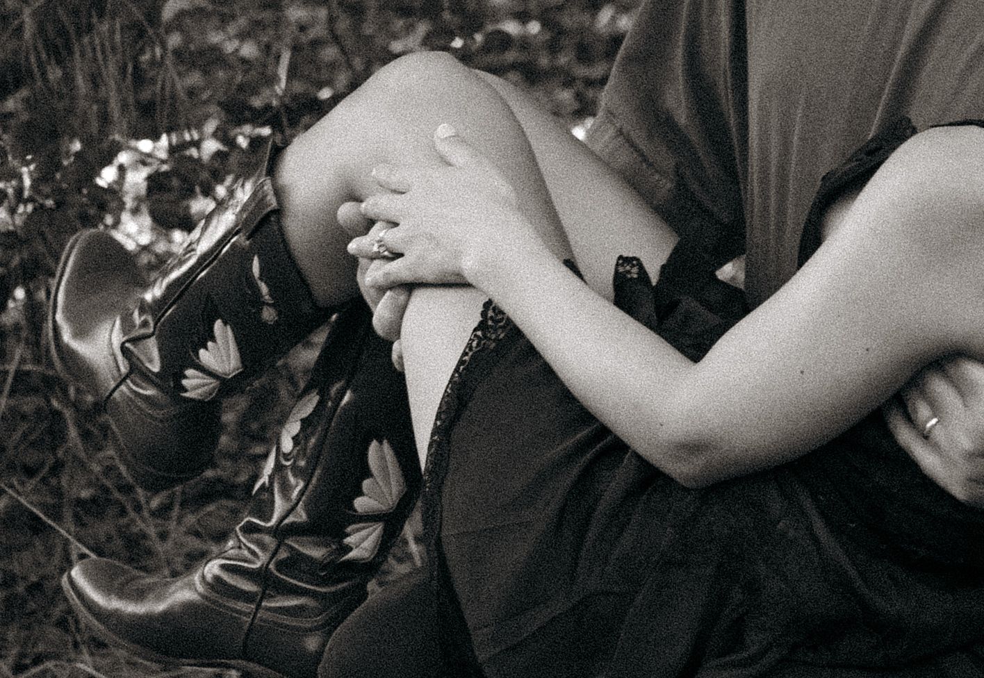 San Diego Couples session - Black and white close-up of hands resting on knees.