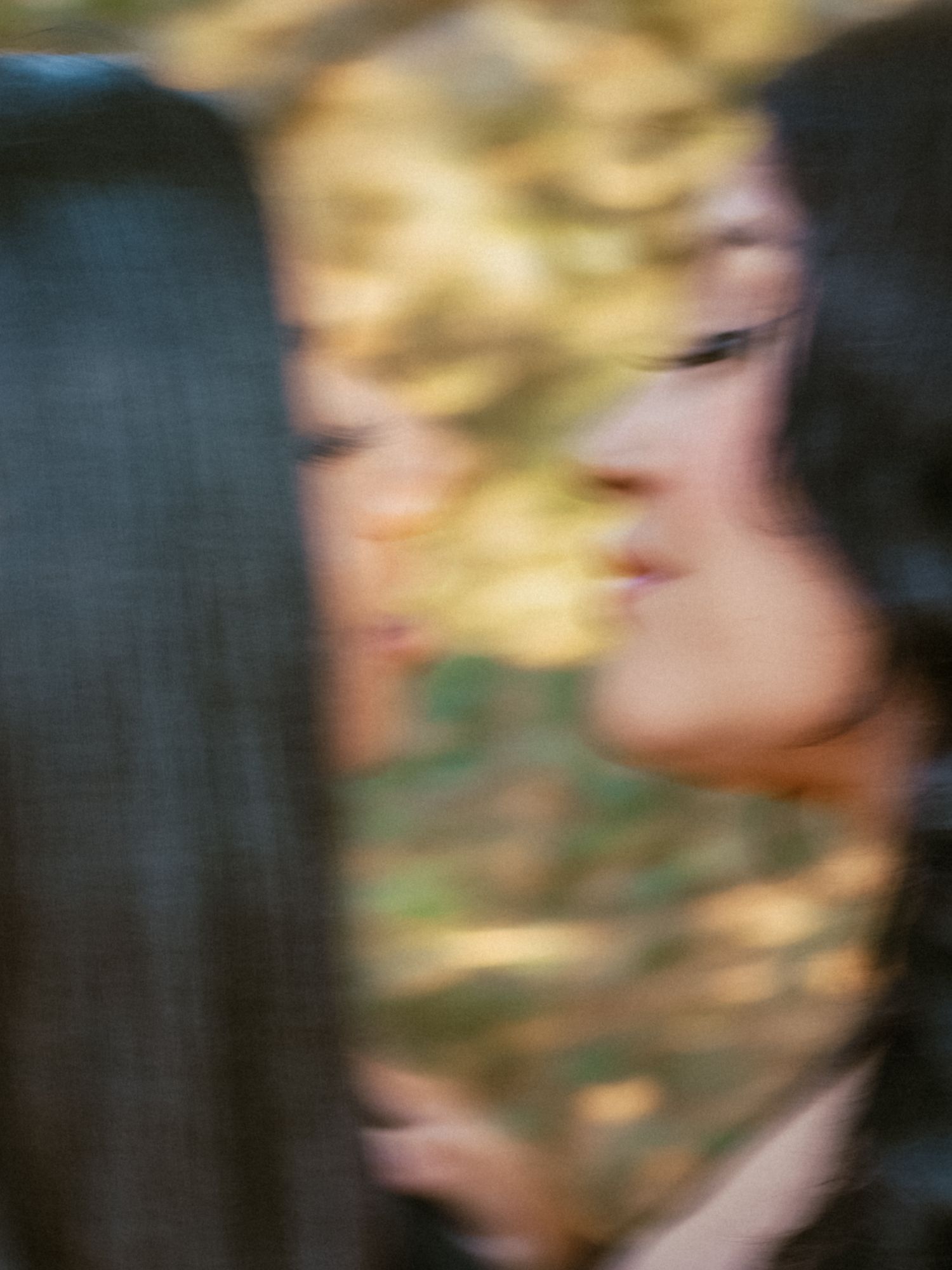 A blurred artistic photo sequence showing abstract motion and movement in golden and dark tones.