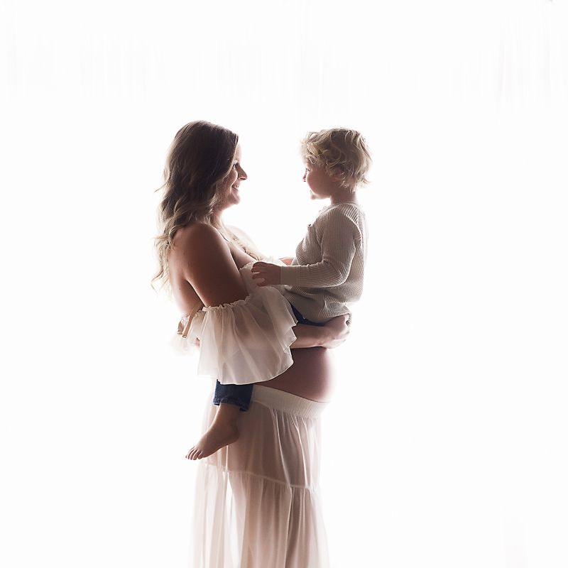 A series of romantic wedding photos showing a couple in white dresses dancing and embracing in soft lighting.