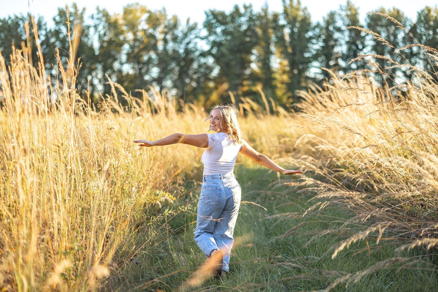 Figure running joyfully through tall golden wheat field at sunset.