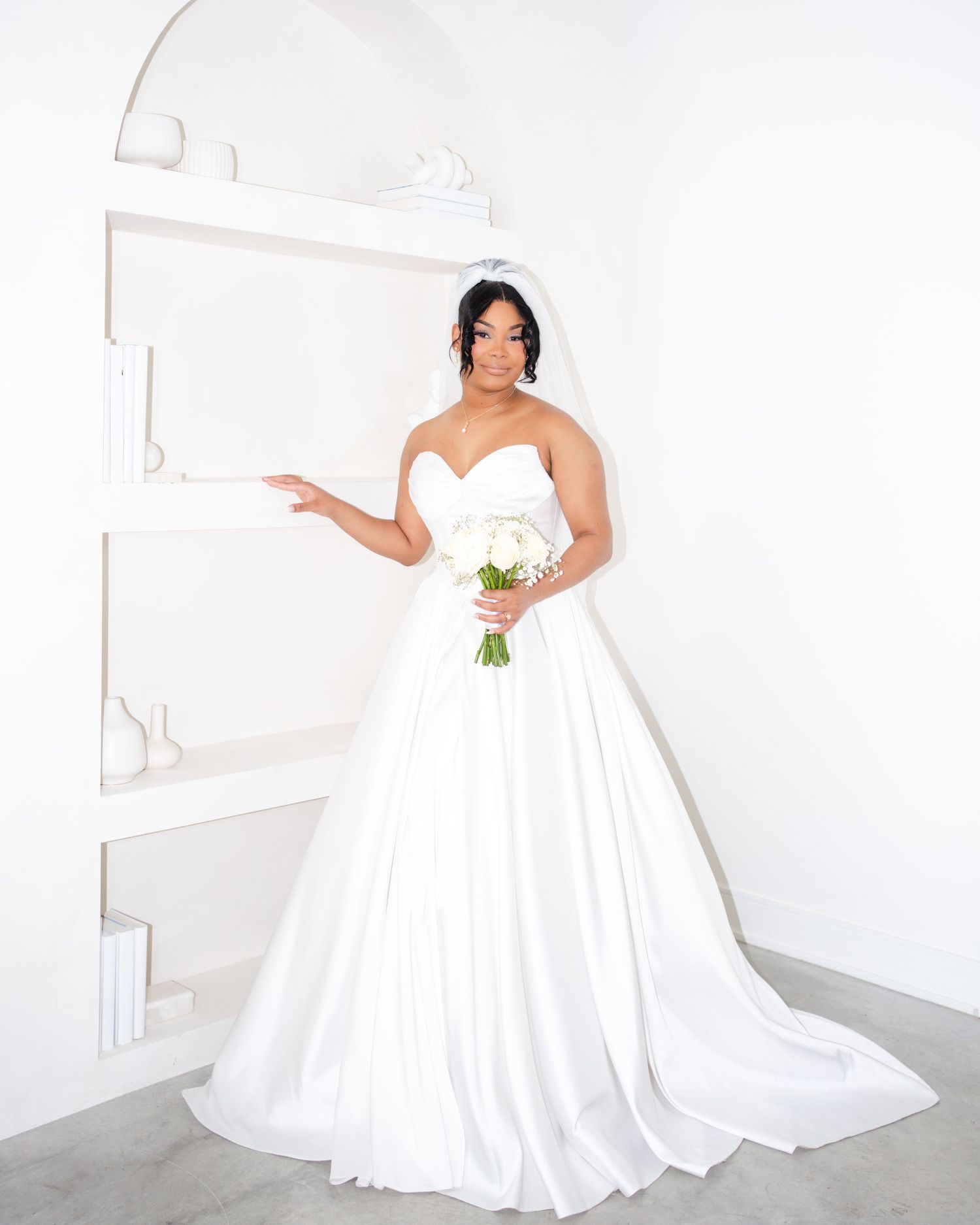 Bridal photography series featuring a white wedding gown in a minimalist studio setting.