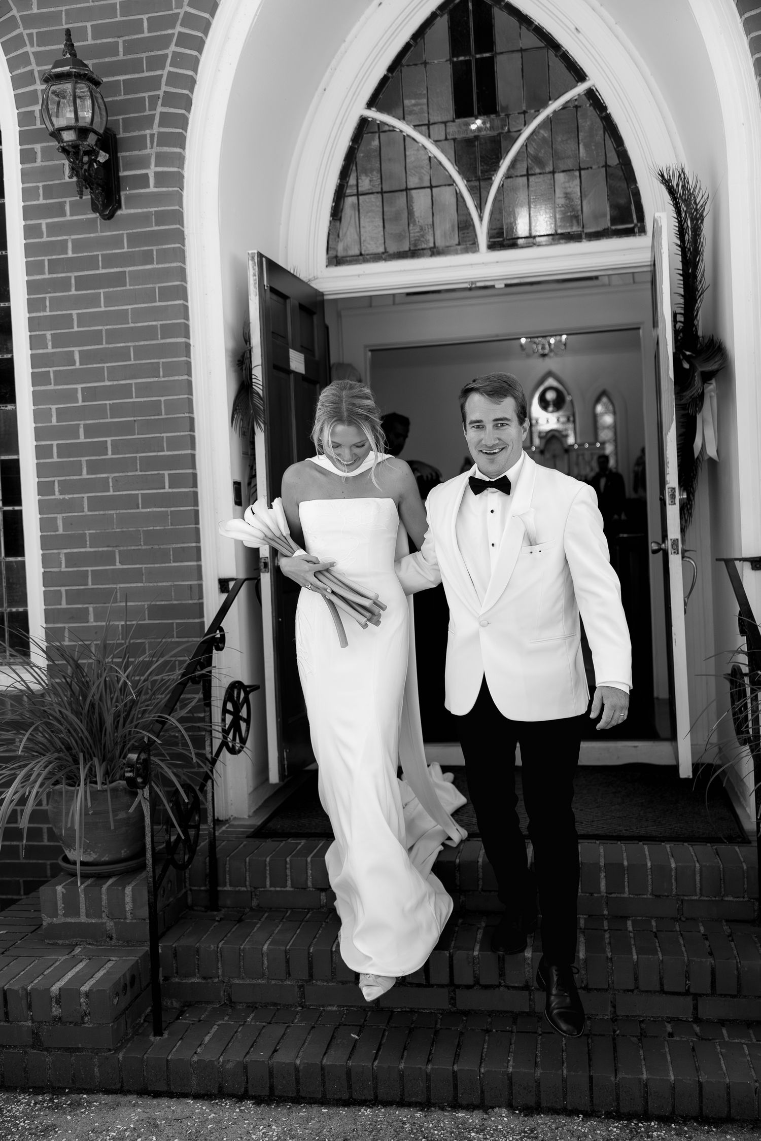 Bride and groom exiting St Marys Catholic Church on Johns Island South Carolina after their wedding ceremony