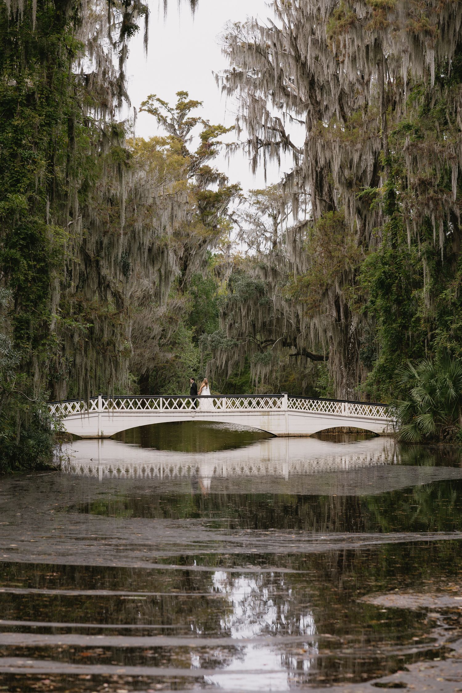Bride and groom on bridge at Magnolia Plantation Charleston South Carolina wedding photography