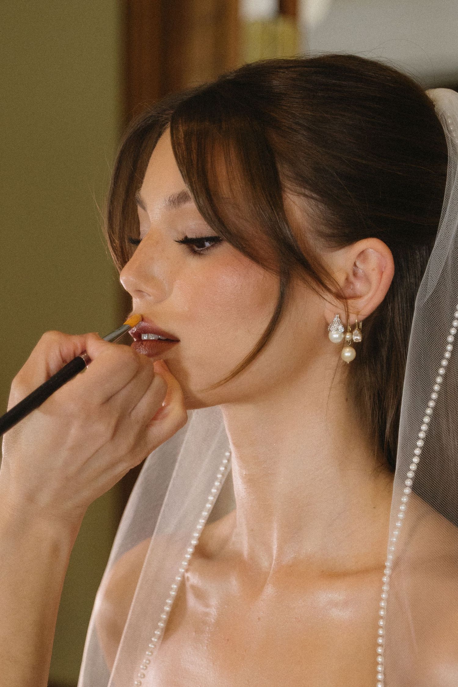Candid bride getting ready on wedding morning at Whitehead Manor Charlotte North Carolina