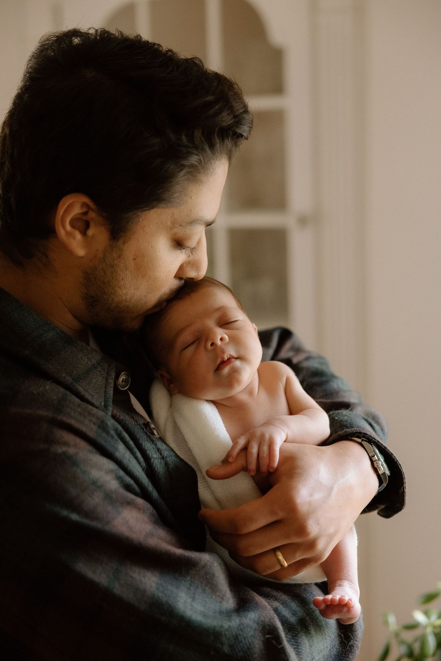 Intimate lifestyle portraits captured in warm indoor lighting.