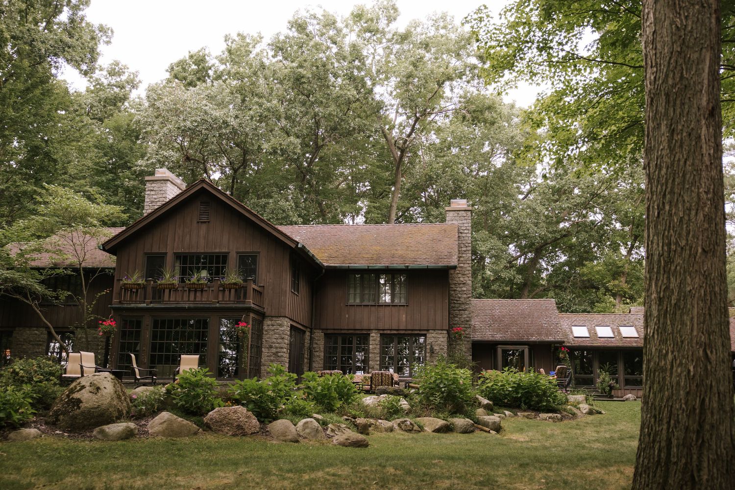 Rustic wooden lodge buildings nestled among trees in a scenic landscape.