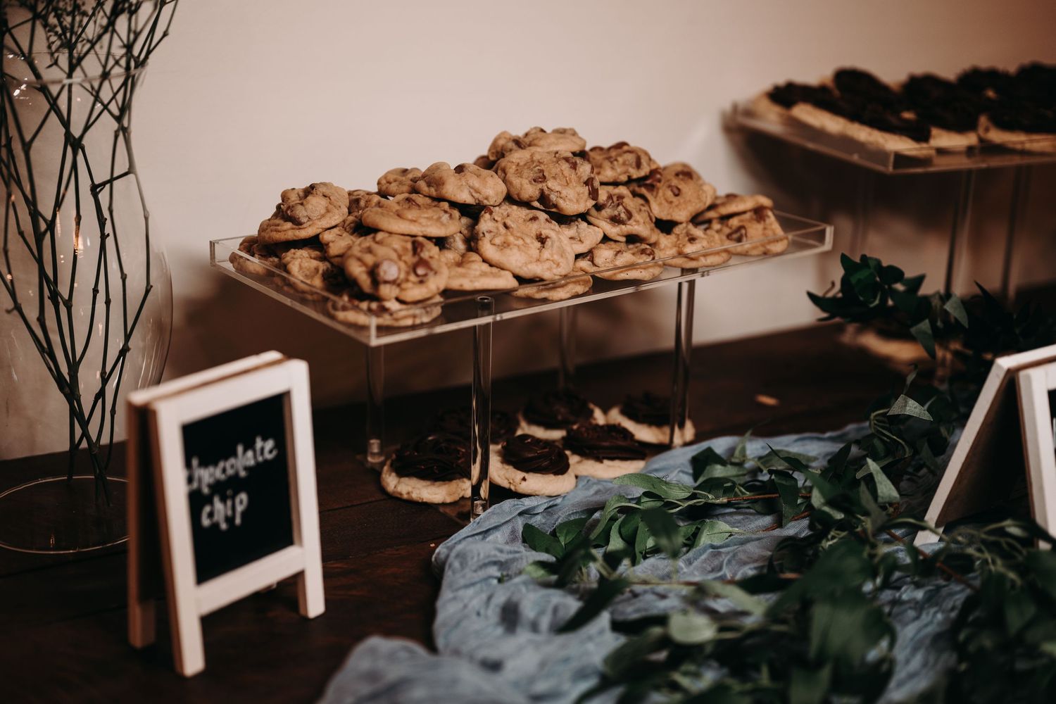 Display of cookies and desserts on a tiered platter at a wedding reception.