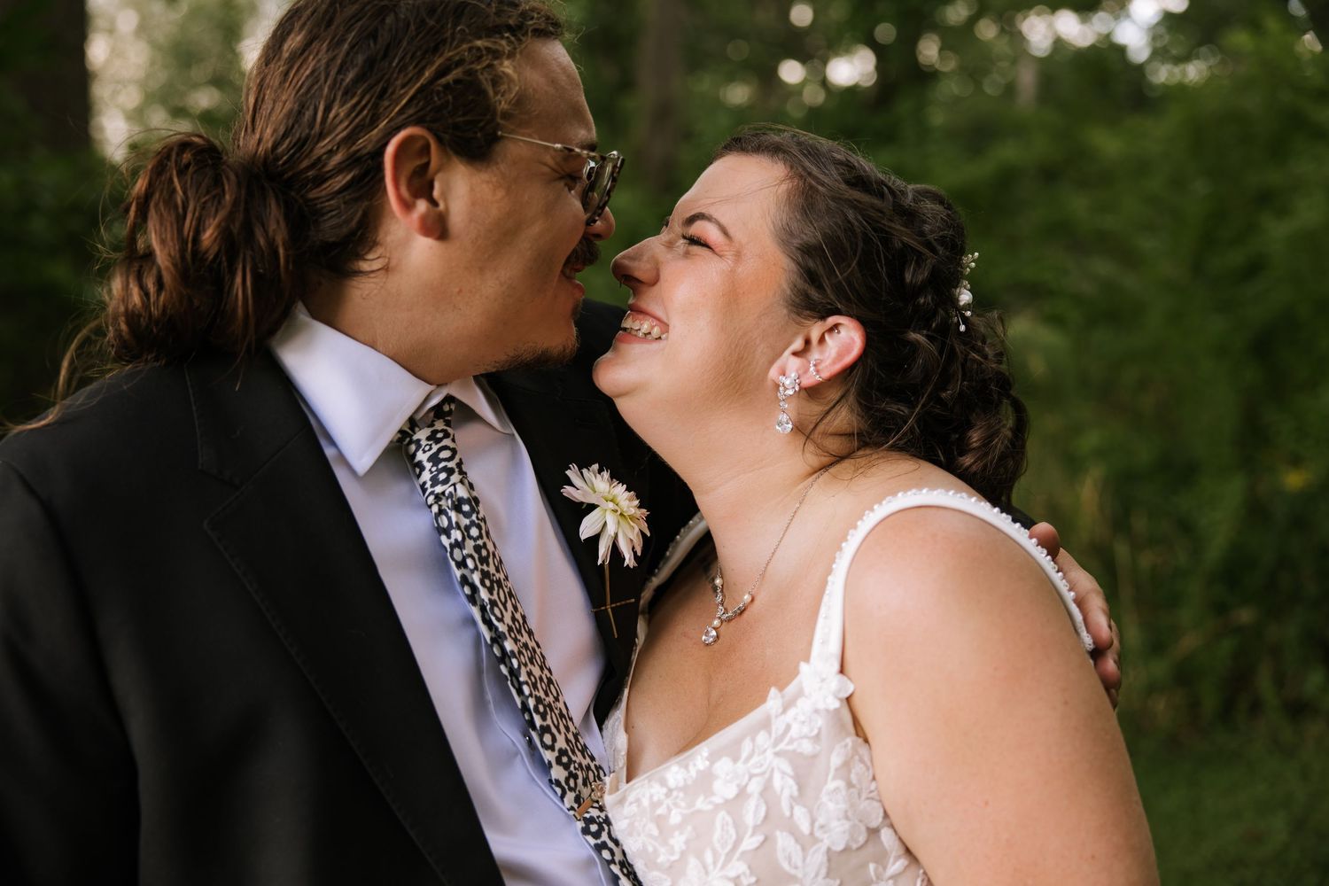 Close-up romantic moment between couple during outdoor wedding ceremony.