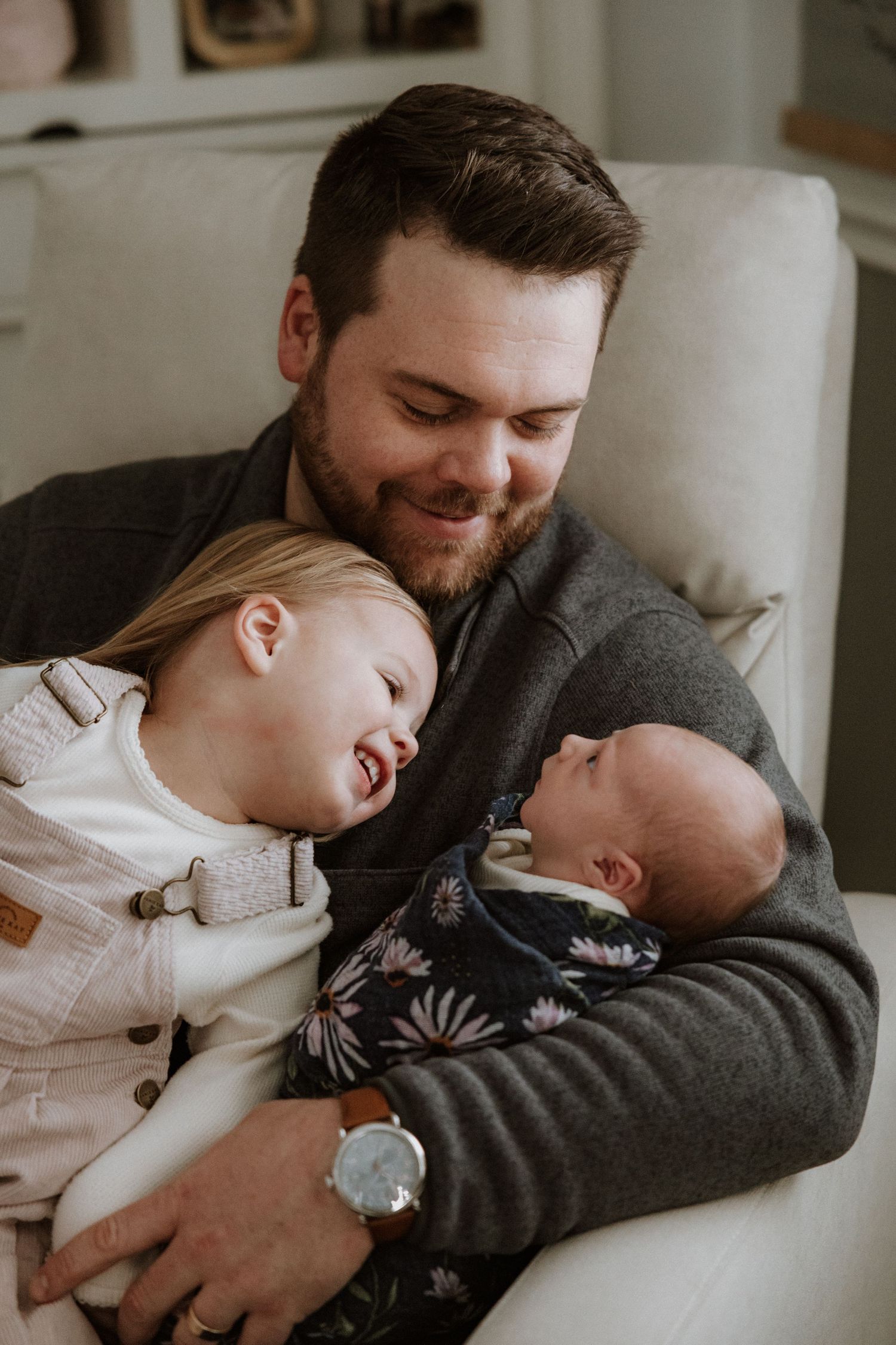 A tender moment captured in a series of close-up shots showing affectionate interaction with a sleeping baby.